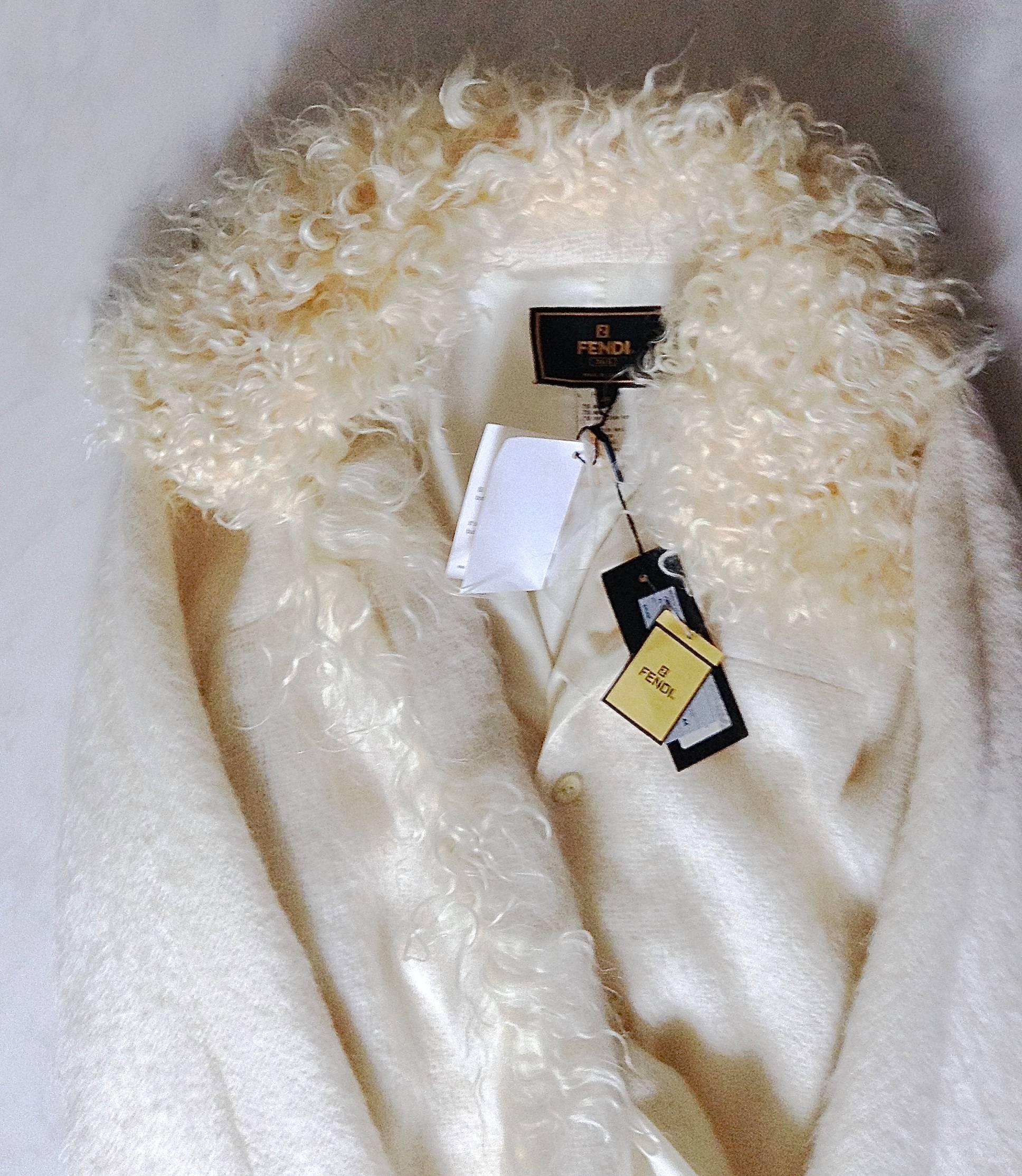  THIS authentic luxurious and sophisticatedly made coat is from FENDI, the   most distinguished fur company. 
 Done by beautiful supple Mongolian curly hair collar with the same fur straight down to the bottom of the coat. 
 The material of the