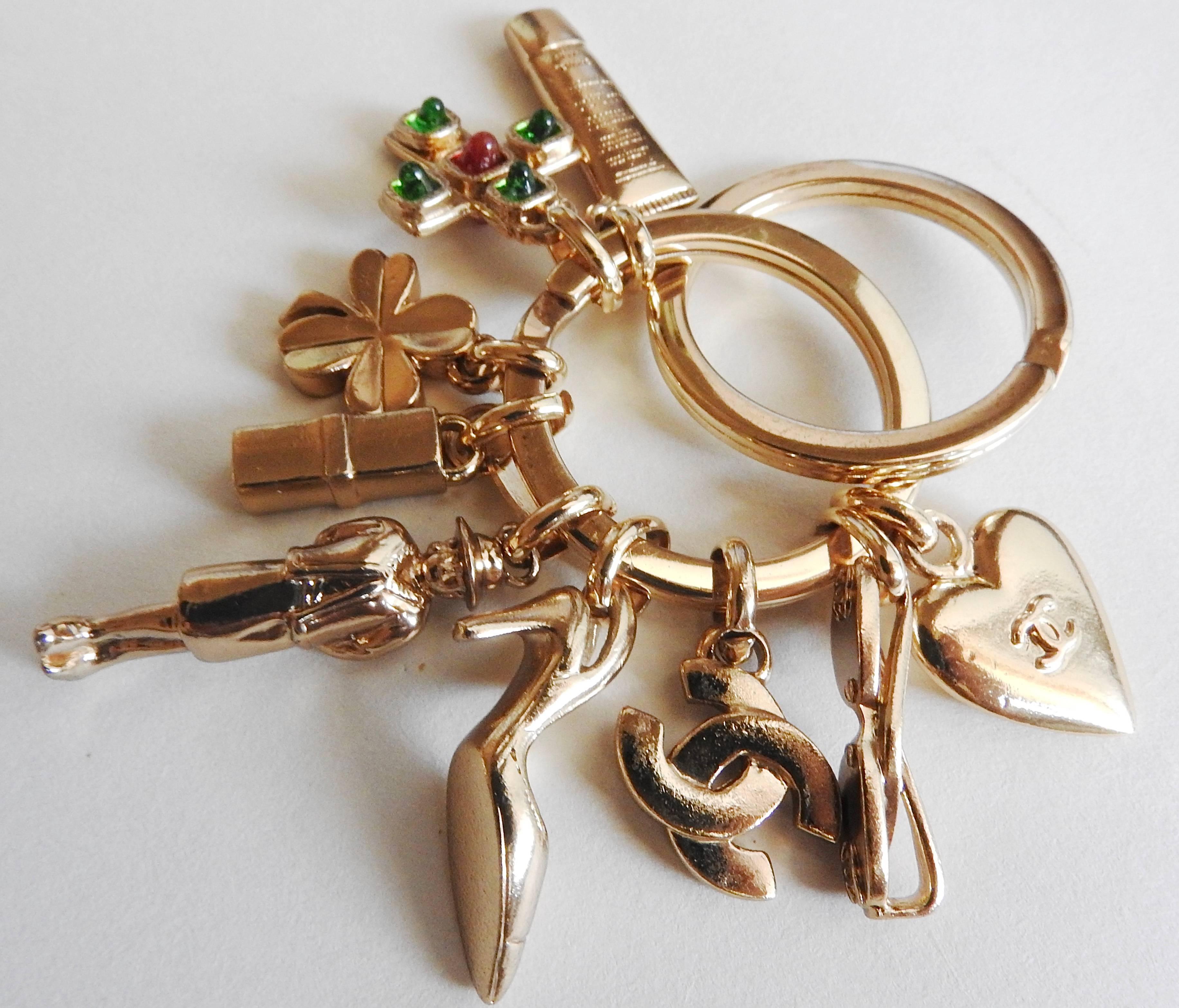 This collectors' 2002P double rings keyring is so complete with all iconic charms, such as sunglasses, heart, Gripoix glass cross, facial cream, shamrock, lipstick, Coco herself, sanders an CC logo. This key ring can be also used as a necklace