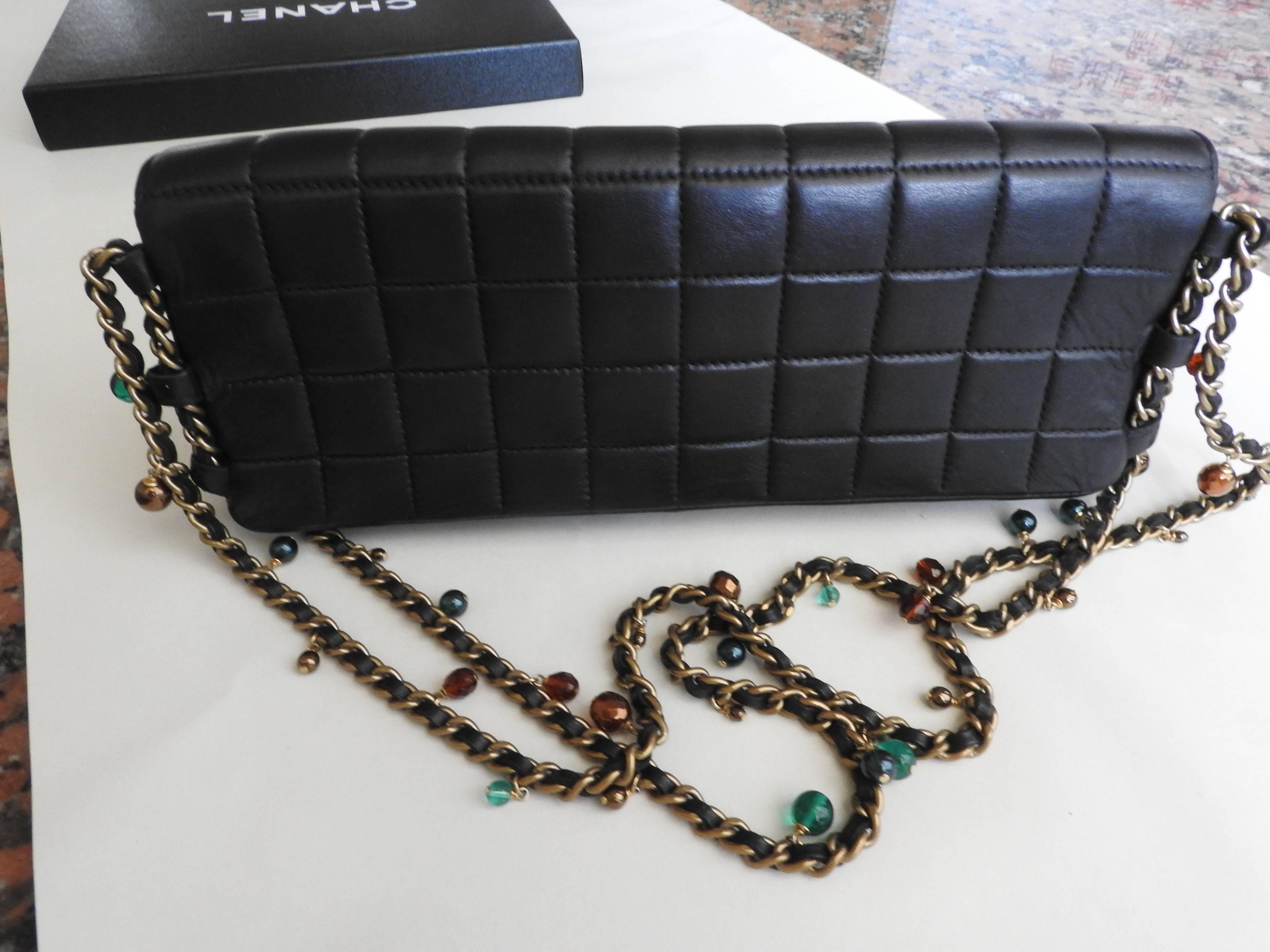 This double jeweled chain bag is so sumptuously adorned with Gripoix glass
 beads, faux pearls, and intertwined with lambskin strips. The material of the
 bag is fully done inside out by black leather. 
 This gorgeous 2003  vintage piece has