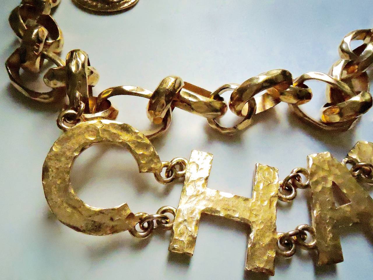 From Chanel 93A . This super fun major runway piece presents a beautiful artisan of Chanel jewellery at Chanel its best year. Fully handmade with rich hammered works. Comprising of 6 large letters : C *H A* N* E* L . and chained with heavy chunky