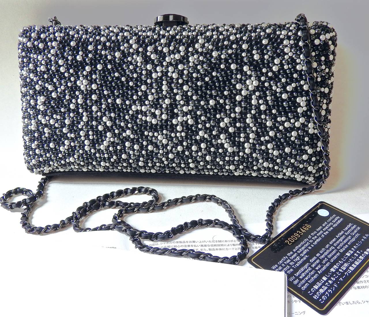 This Chanel pearled chain clutch bag is from 2014 Pre-Fall collection. 
 Sumptuously embellished with finest quality of grey and creamy white pearls and black beads. 
Soft lambskin lining with suede leather bottom.
3 toned pearls give this clutch