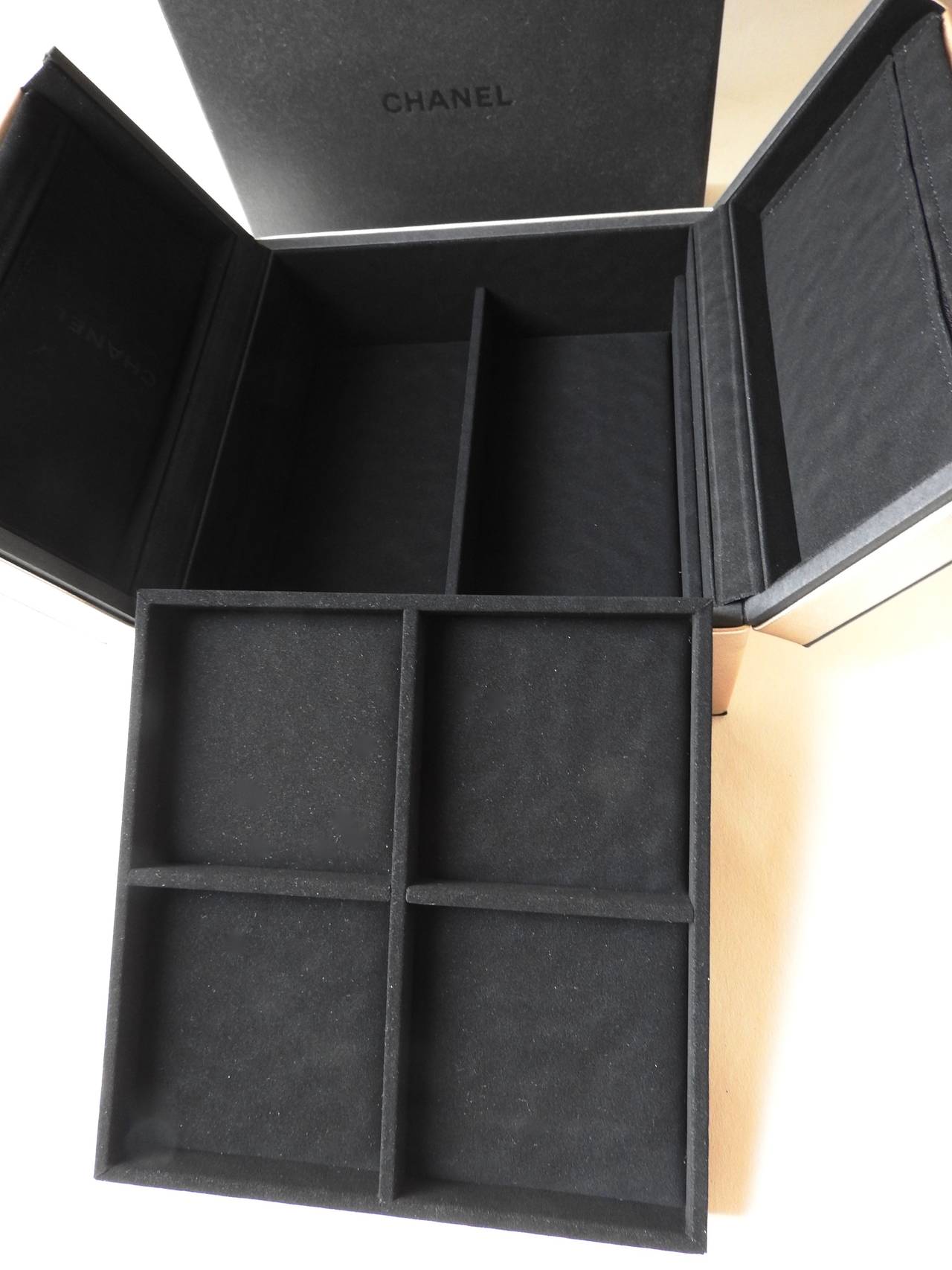 Each year Chanel company prepares some present for their top tier customers and delivers these present in person by their representatives.   
This beautiful lambskin suede and velvet 2-story jewellery storage box is one of the top tier customer's