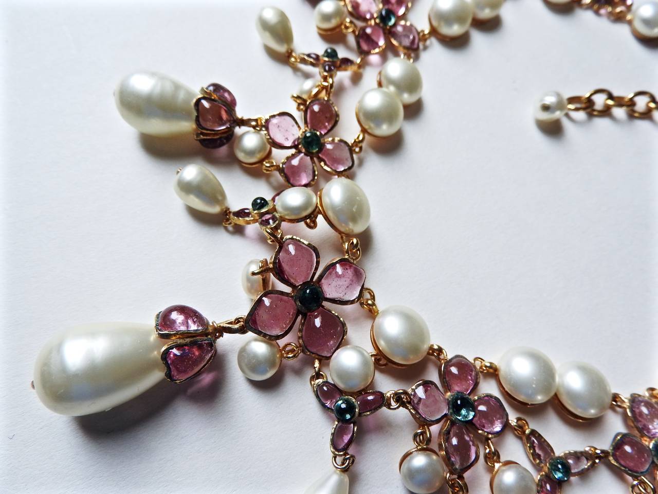 This outstanding full Gripoix clustered flower oversized teardrop pearl necklace is from Chanel 1995 Spring with stamp on the back, that reads CHANEL 95P MADE IN FRANCE. 
The arrangement of its bright pink colored glass flowers ( Pâte de verre )