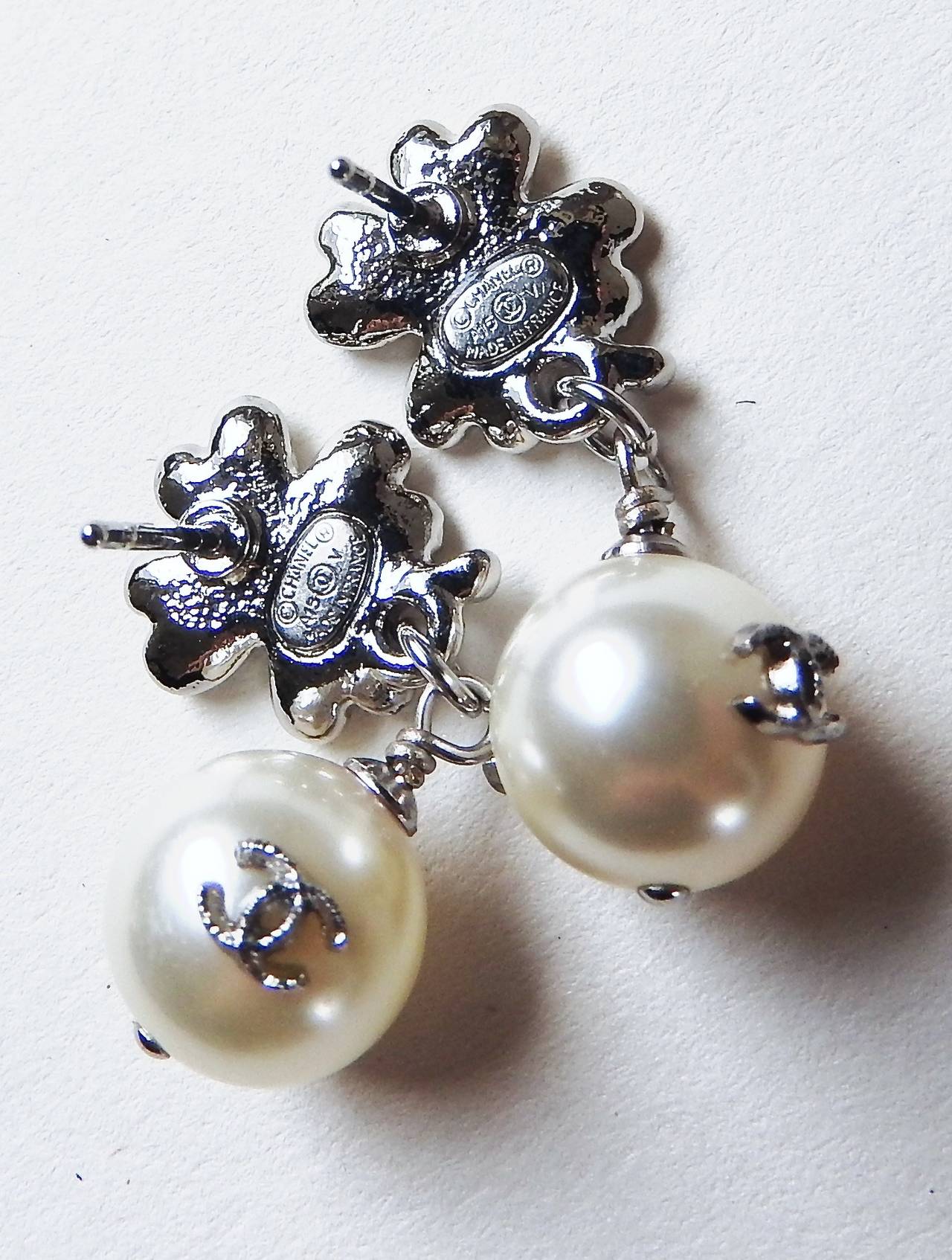 THESE earrings are so beautifully done with finest quality of Swarovski crystals and glass pearls and adorned with 2 silver CC logo on two sides of each pearl. 
When wearing them the CC logos would show on two side of the earrings, not as shown in
