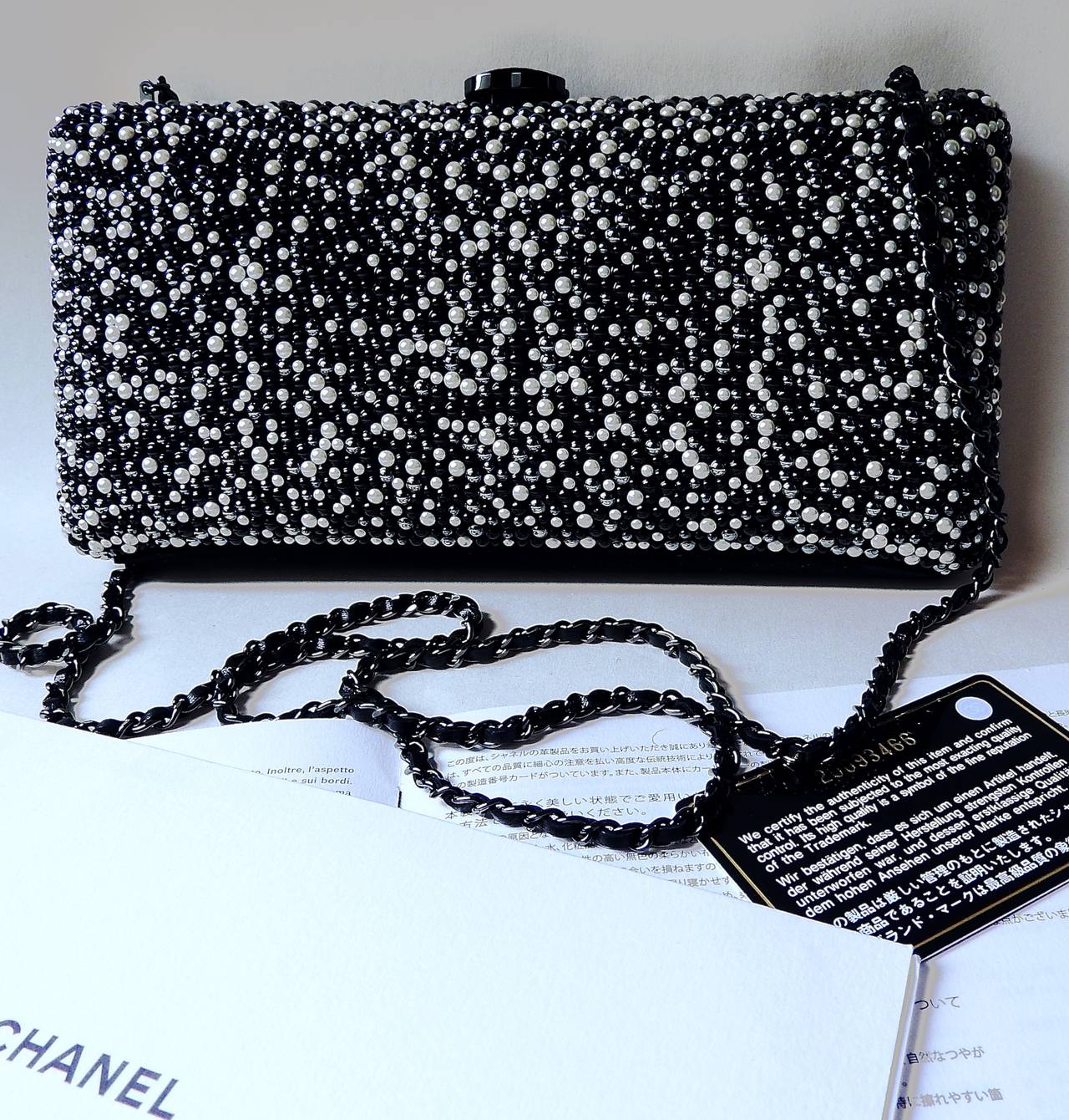 This Chanel pearled chain clutch bag is from 2014 Pre-Fall collection. 
Sumptuously embellished with finest quality of grey and creamy white pearls and black beads. 
Soft lambskin lining with suede leather bottom.
3 toned pearls give this clutch