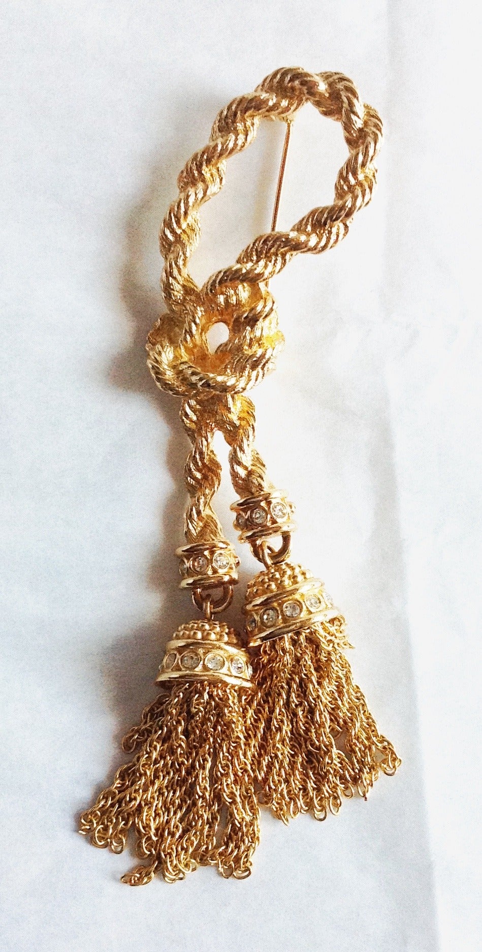 This well made gorgeous vintage Christian Dior extra long rope brooch features double tasseled drop. Each tassel drop is made with crystal roundels. 
Never been used in pristine condition. Shining gold with no any kind of issues and even no signs