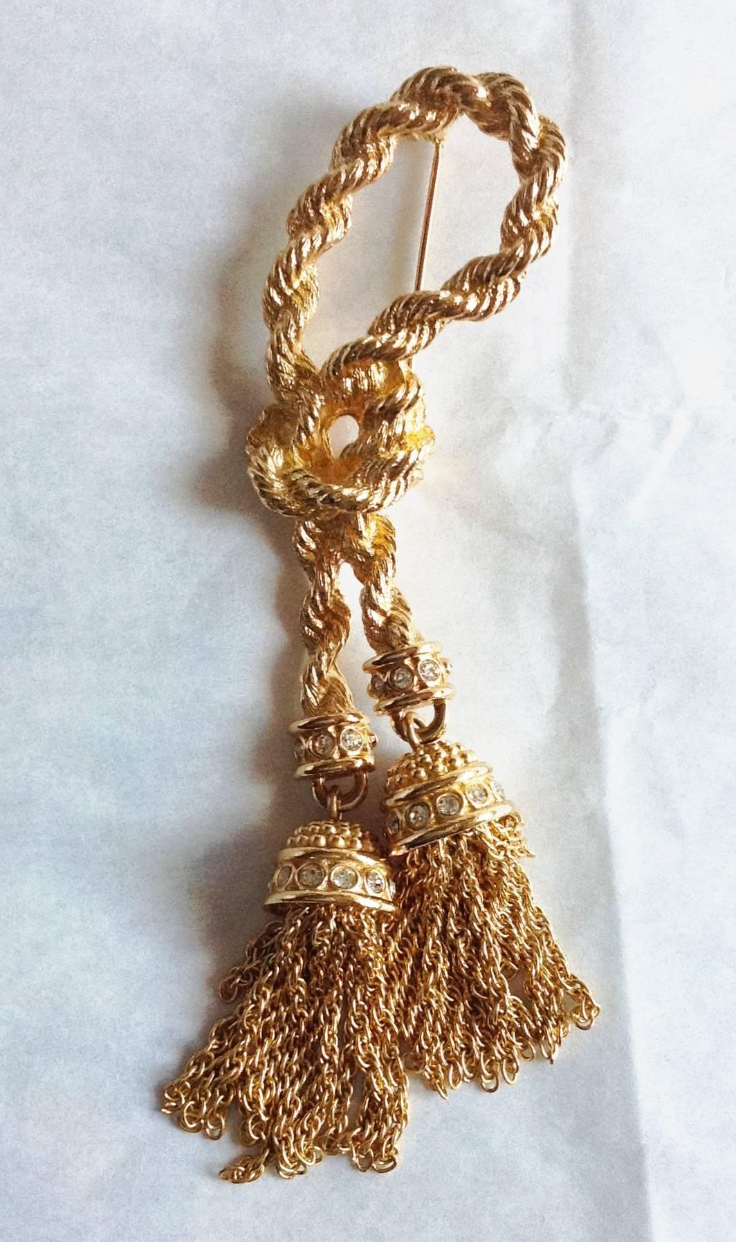 This well made gorgeous vintage Christian Dior extra long rope brooch features double tasseled drop. Each tassel drop is made with crystal roundels. 
Never been used in pristine condition. Shining gold with no any kind of issues and even no signs