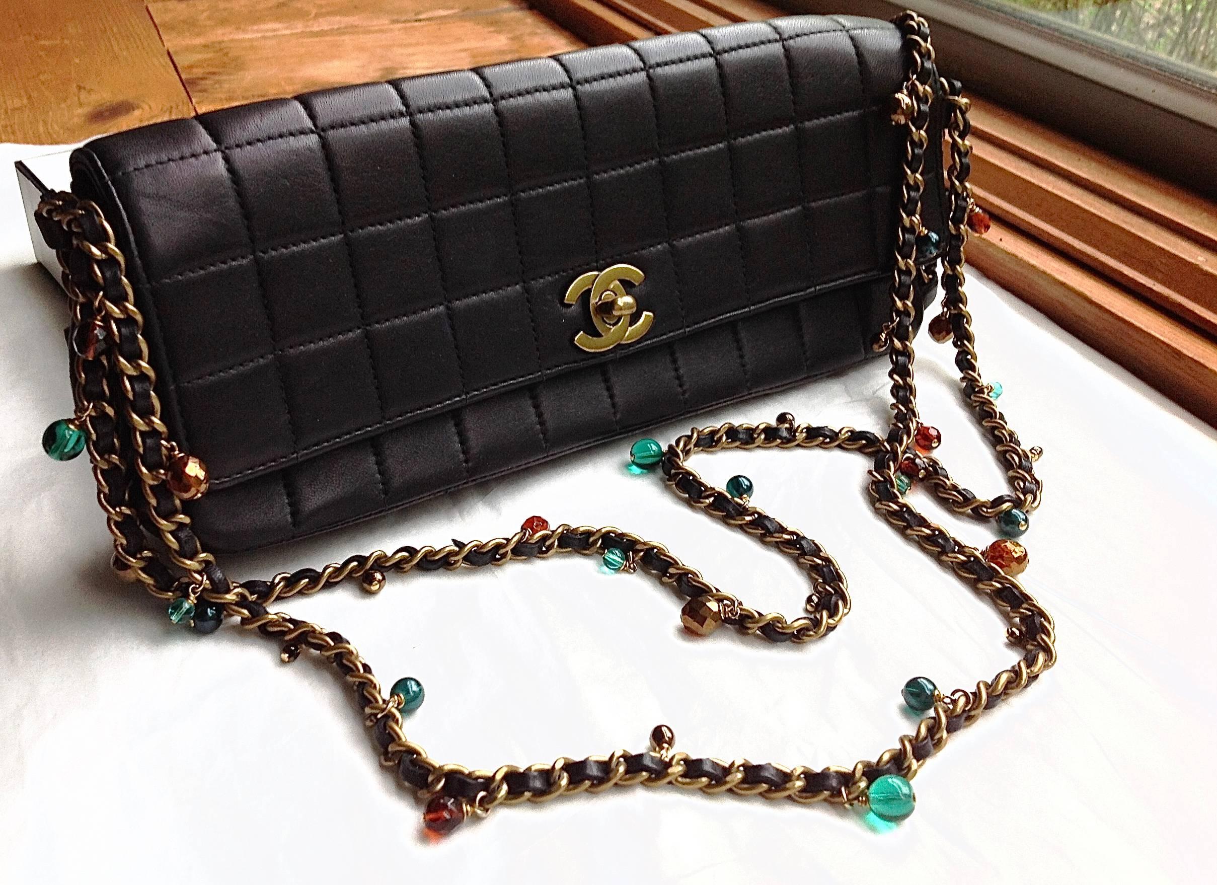 This double long jewelled chain bag is so sumptuously adorned with Gripoix glass beads, faux pearls, and intertwined with lambskin strips. The material of the bag is fully done inside out by black lambskin. This Gorgeous 2003 vintage piece is clean