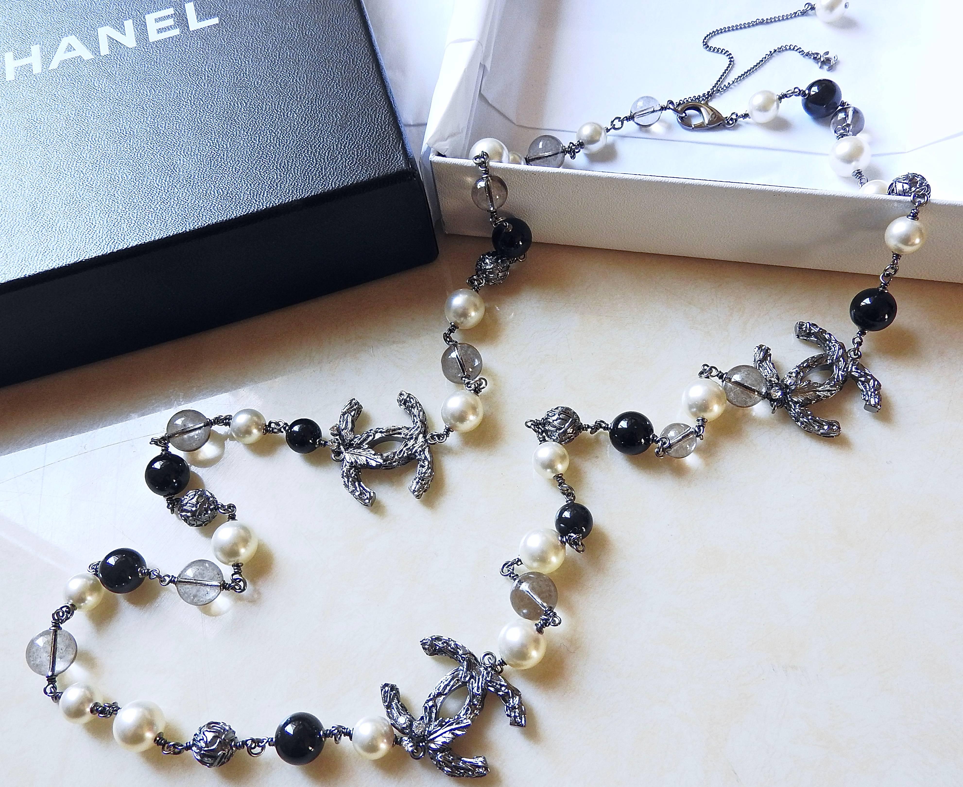 THIS 2013 Cruise Chanel long necklace is so beautiful with all highest qualities for your important events. Constructed with solid gunmetal 3 D jeweled tree, glass bead, smoke quartz, gunmetal flower bead and highest quality of creamy white pearls +