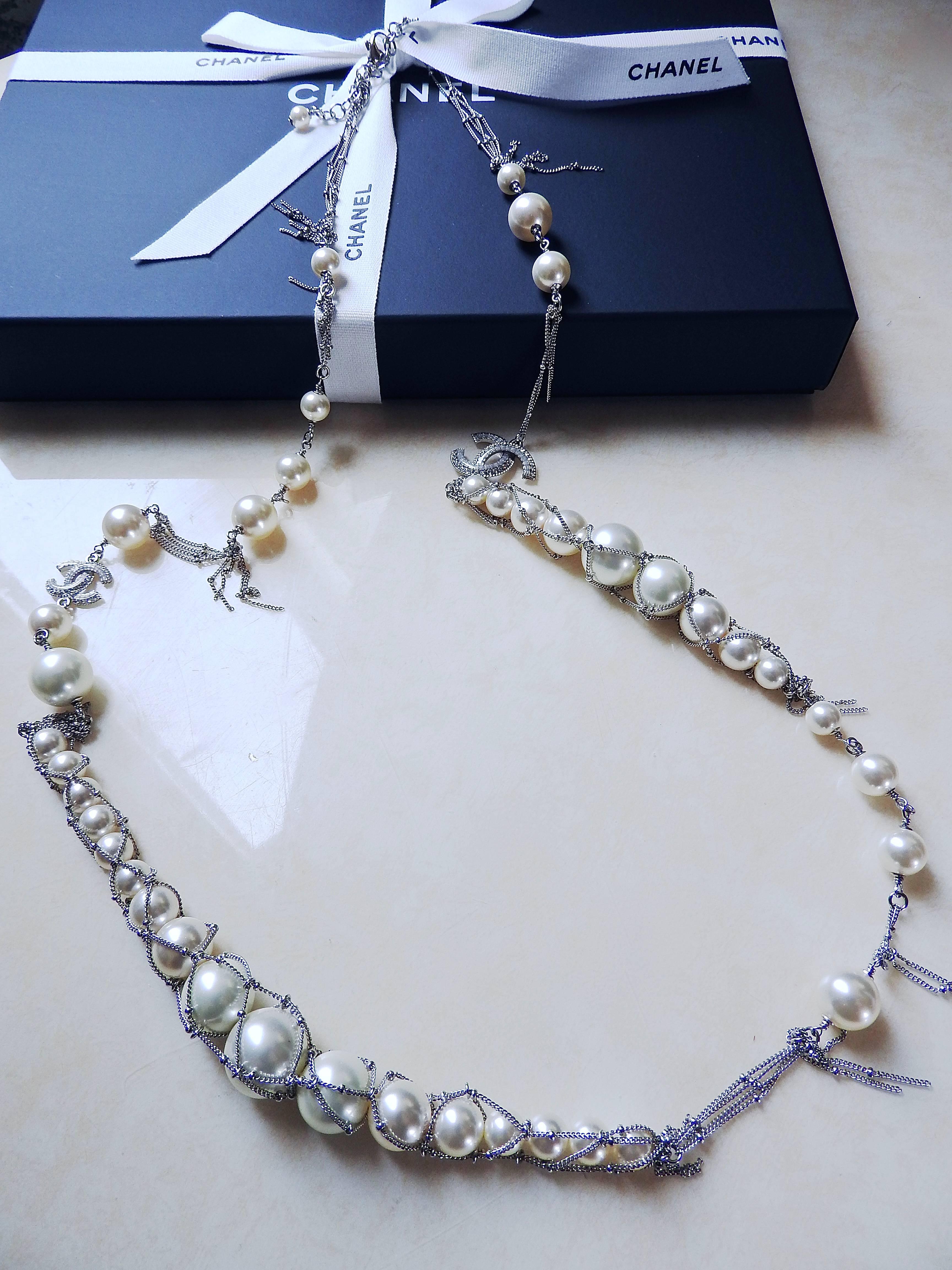 This gorgeous and sweet long fishnet pearl necklace is from Chanel supermarket grocery series. 
Designer using fishnet to present joy of harvesting sea pearls.  The whole piece is done in an asymmetric and free style with such much exquisite and