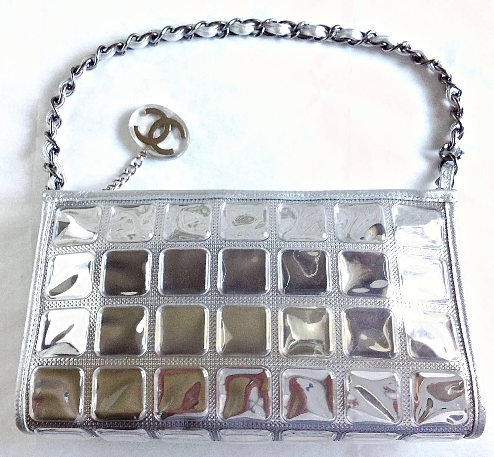 This cute and eye catching bag is in hard to find  mint condition. 
Features transparent vinyl made Ice cube with leather strips wrap around the edges, and  silver metal chain hand drop which intwined wit silver leather. Silver grey lining ( camera