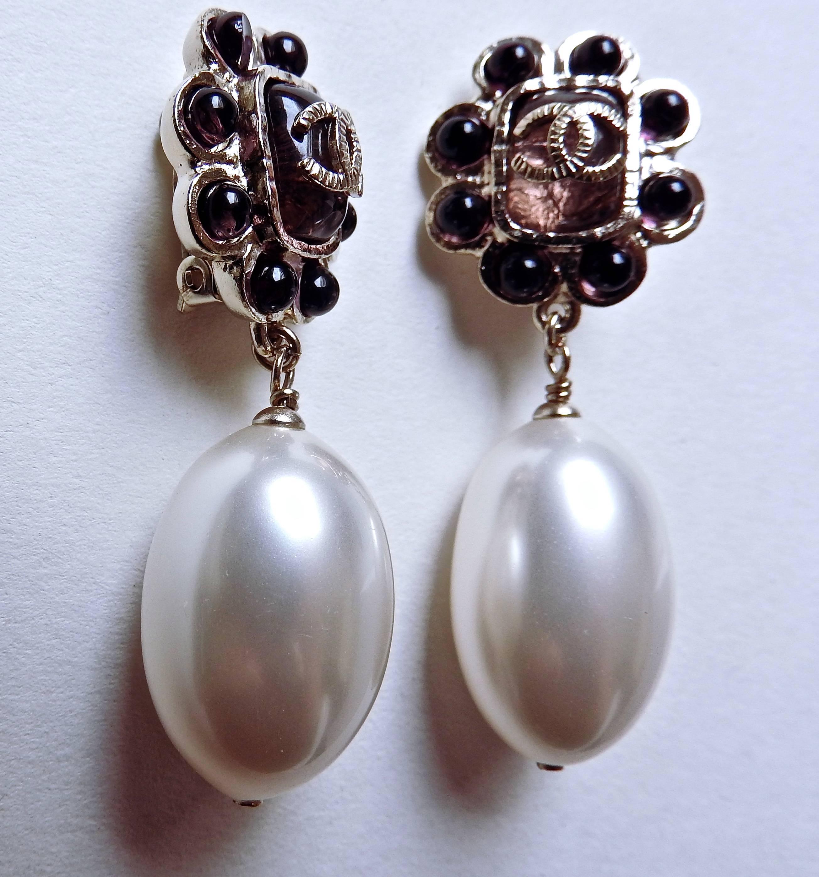 So elegant so eye catching ! 
These earrings are from Chanel 08P done by handmade resin in French plum colour and dangle with jumbo pear shaped light weighted pearls. 
Photos were taken under different natural lighting, so their colours look a