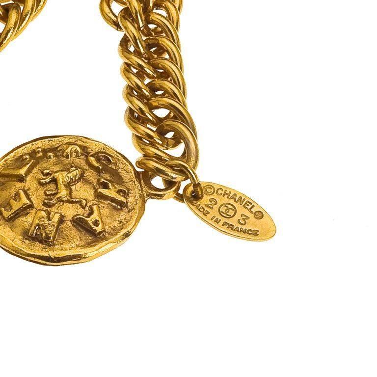 Chanel long sautoir necklace with lion motifs and Chanel logos.