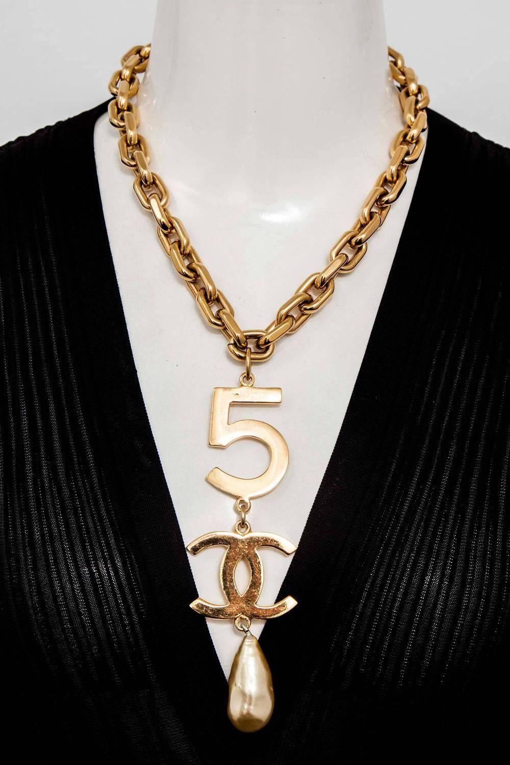 Chanel long necklace with 5, CC motif and pearl. Signed Chanel. Very rare. Length 18.5 inches, Front drop 5.5 inches.