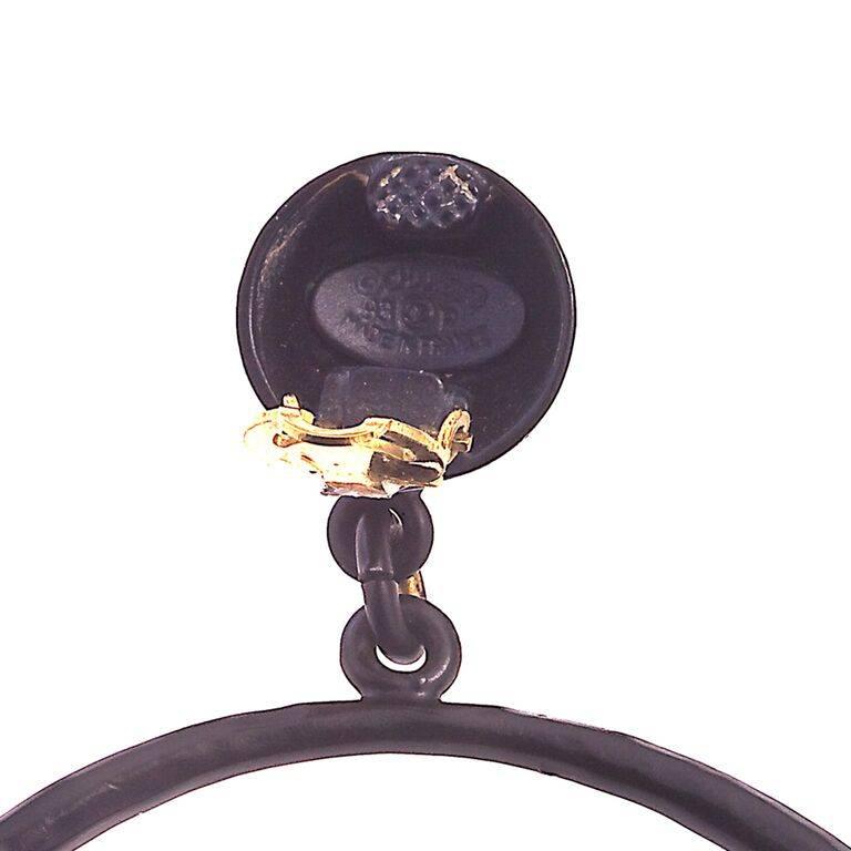 Chanel black and gold hoop earrings with CC logos.
Signed Chanel 93P Made in France. The hoop is 2.6 inches in diameter.