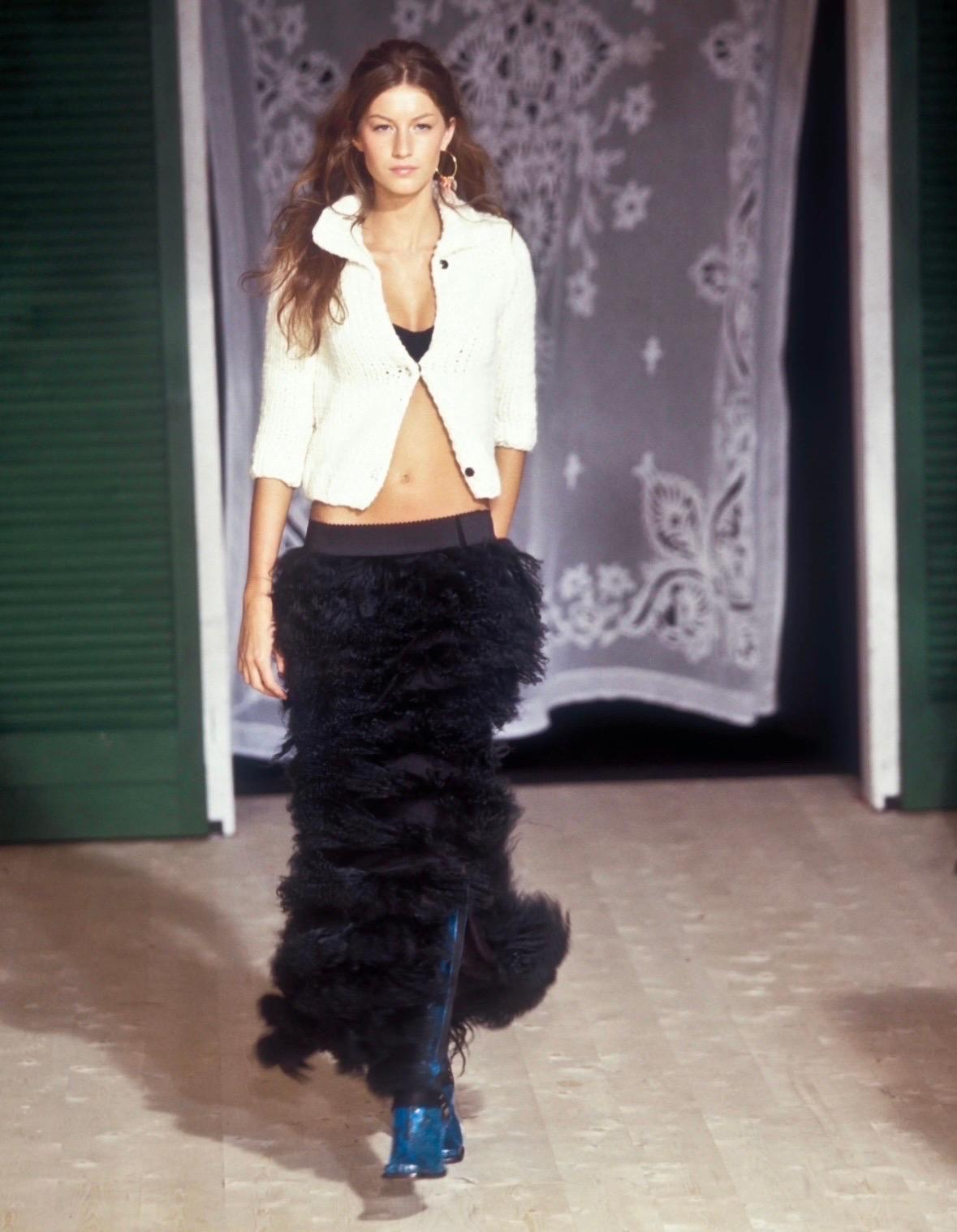 Presenting a black Mongolian lamb Dolce and Gabana maxi skirt. From the Fall/Winter 1999 collection, this fabulous skirt debuted on the season's runway, modeled by Gisele Bündchen. Constructed of layers of curly lamb fur this rare and unique skirt