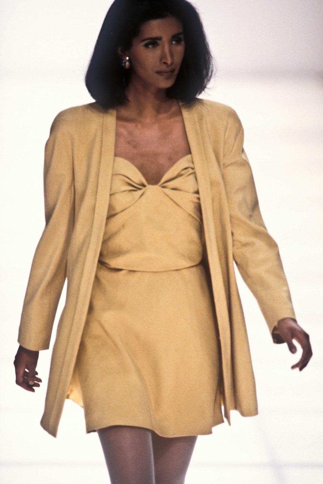 From the Spring/Summer 1991 collection, this chic mustard silk Giorgio Armani strapless crop top features a sweetheart neckline with a twisted effect at the bust. This versatile vintage Giorgio Armani top debuted on the season’s runway. Easily