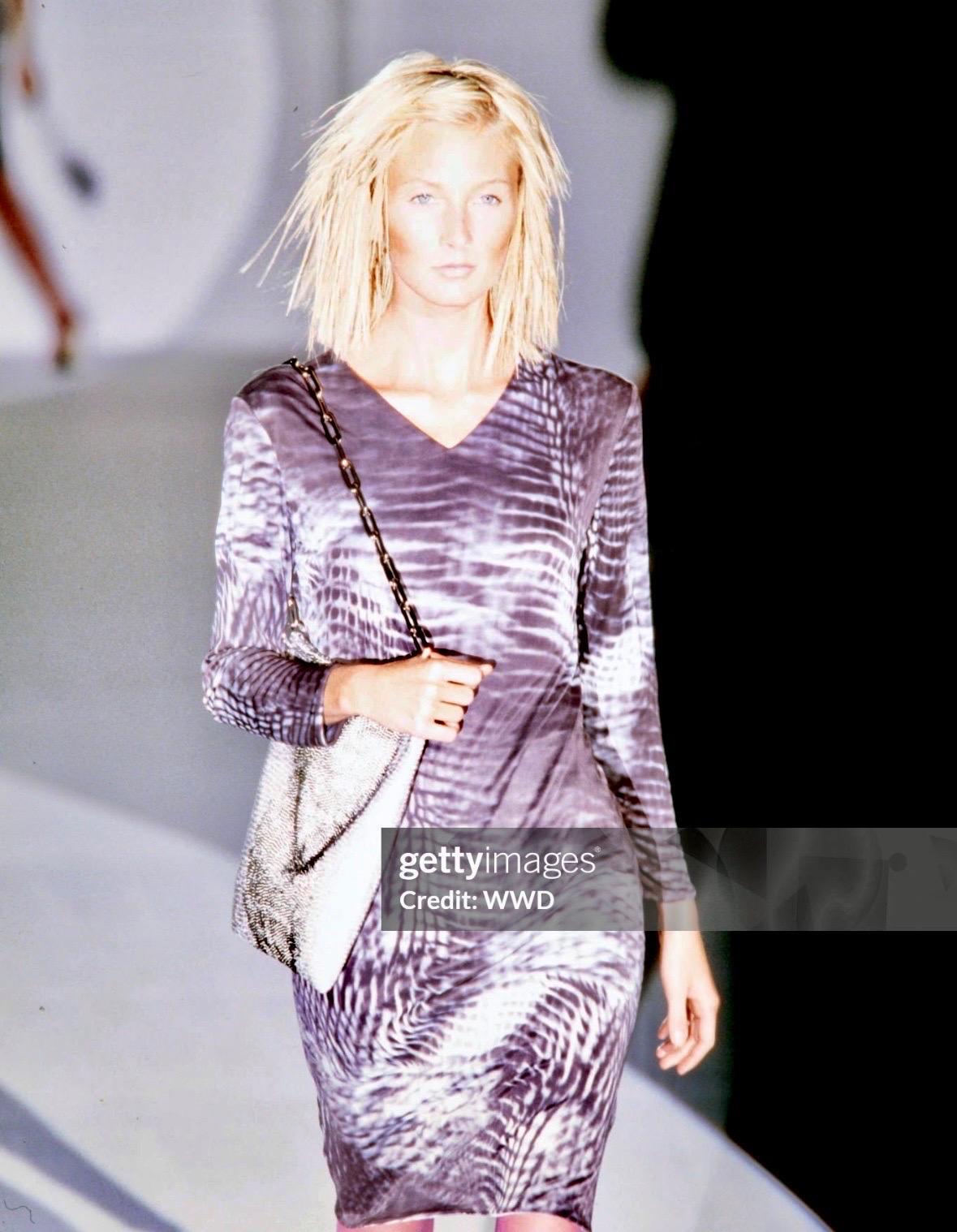 Tom Ford designed this stunning grey beaded tote for Gucci's Spring/Summer 2000 collection. The slouchy tote is intricately hand-beaded with countless iridescent beads, forming a striking snakeskin pattern. A variation of this bag debuted on the