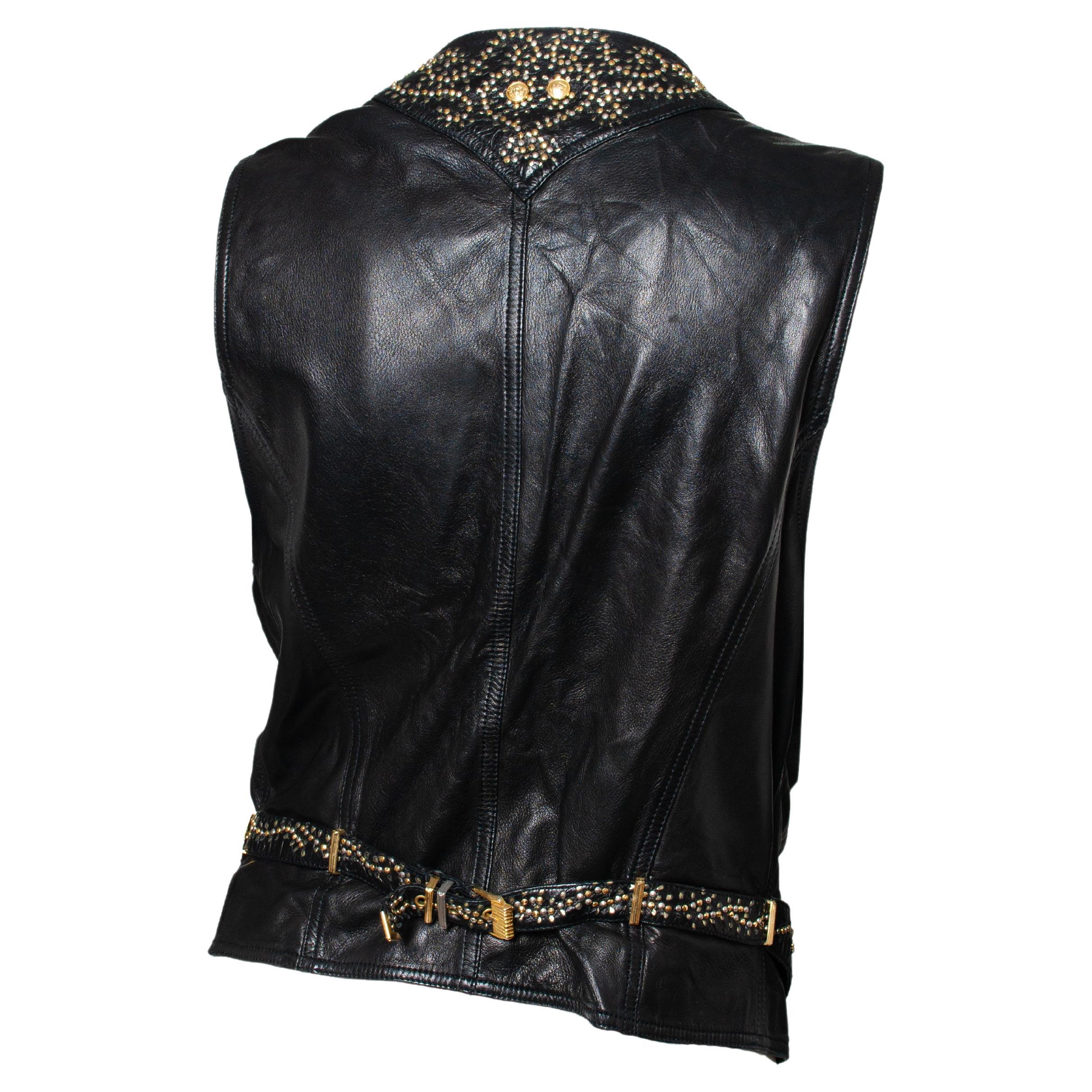 From the Fall/Winter 1992 'Miss S&M' bondage collection, this leather vest features gold and silver studs arranged in a beautiful spiral pattern. This vest has two pockets at the breasts with studs and gold Medusas. The back is adorned with