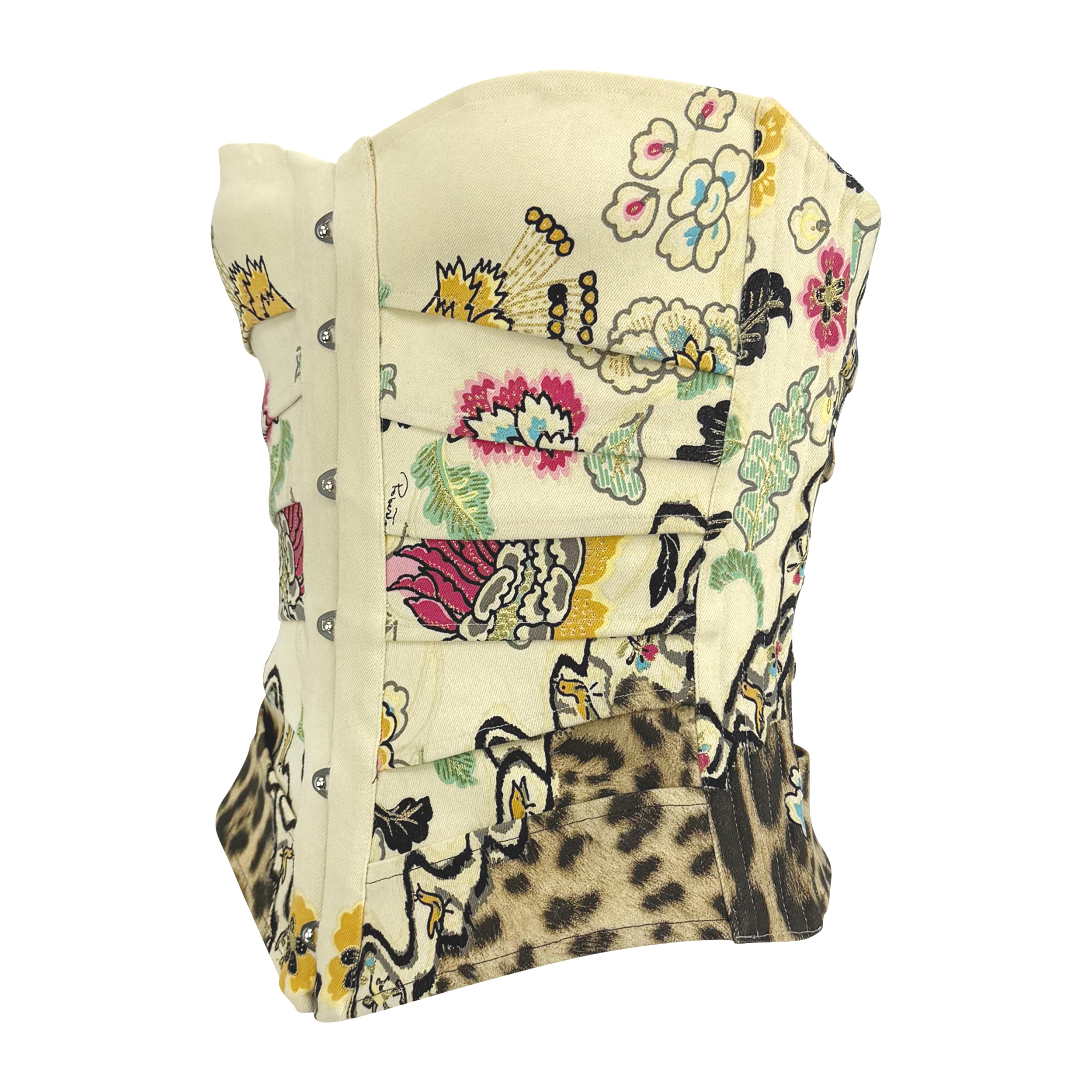 From Roberto Cavalli’s Spring/Summer 2003 collection, this structured cream corset showcases an intricate chinoiserie floral and animal print. The design features front hook closures and a dramatic lace-up back for a customizable fit.

Approximate
