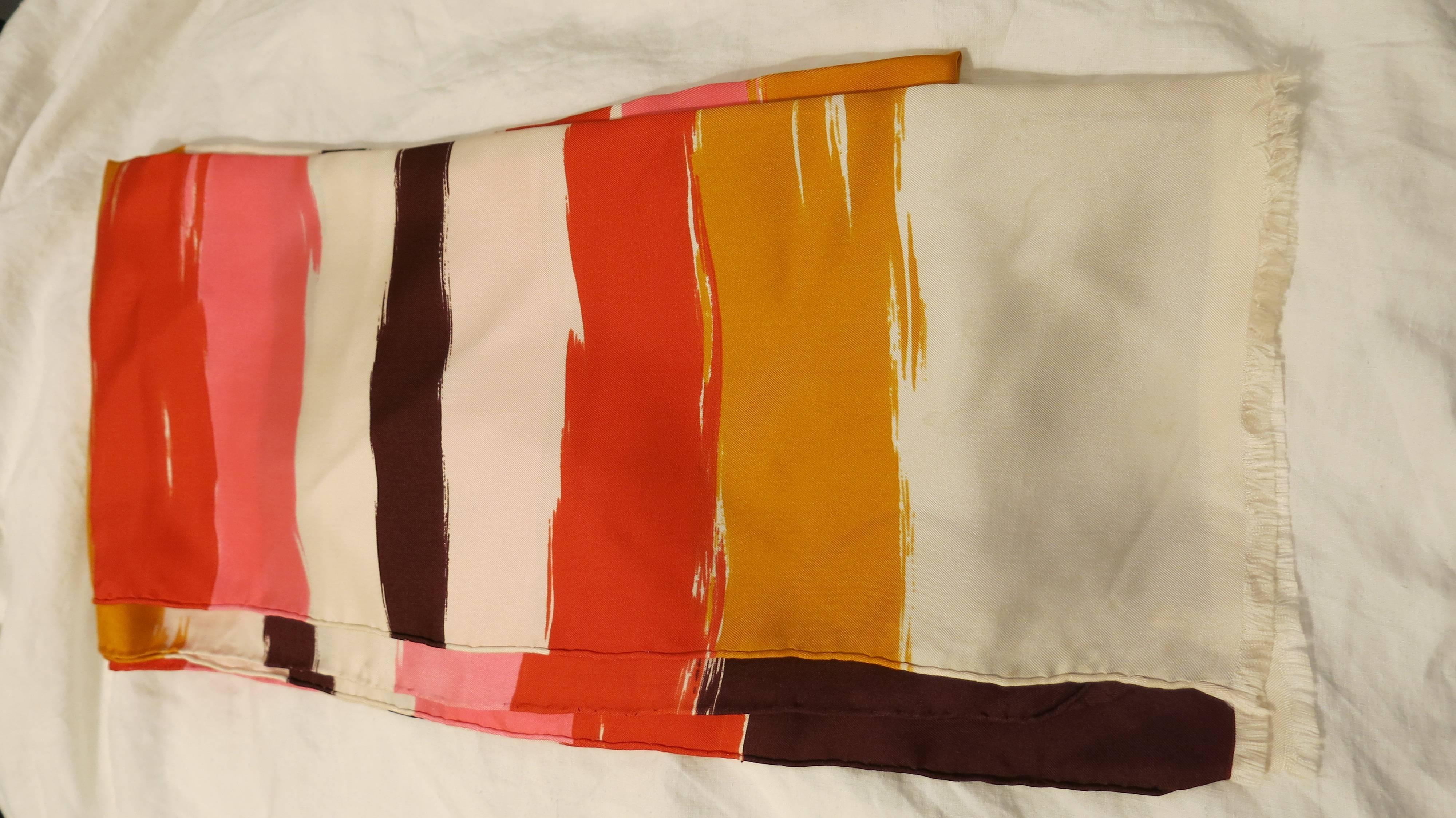 Simple and beautiful cream silk Balenciaga neck scarf with tri-color striping throughout. Frayed edges and rolled trim. Designer signature printed once in bottom right hand corner. Would make a beautiful headscarf, as well. Please note the