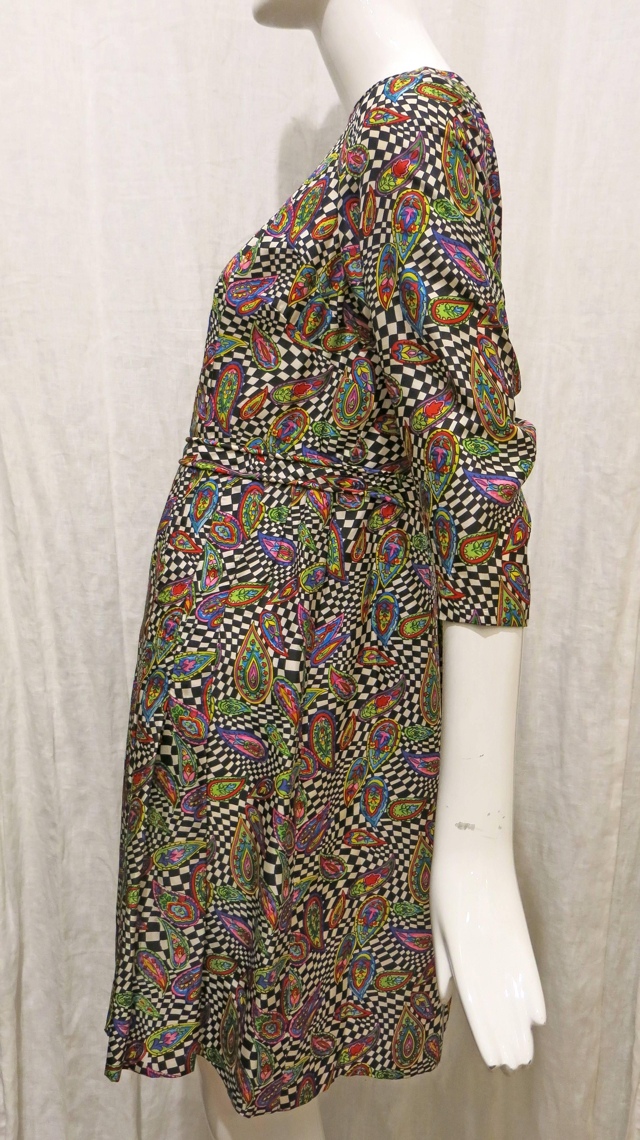 Psychedelic paisley and black and white check print handmade dress. Hem is handsewn. 3/4 length sleeves. Slight v at neckline. Pleated. 