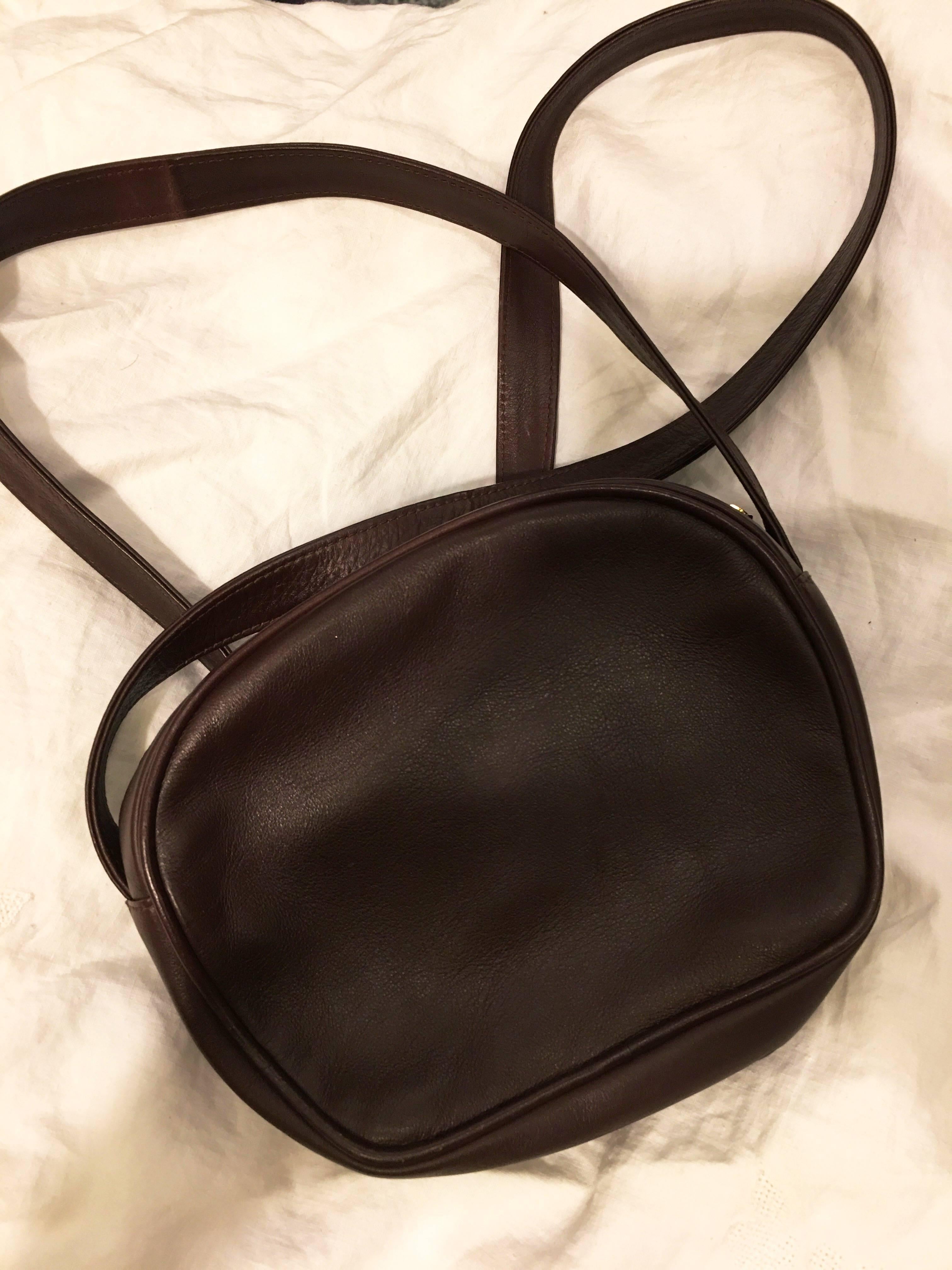 Brown leather Paloma Picasso shoulder bag with logo gold tone X on front and zipper pull of the bag. Bag zips at the top. Small gold tone plate on inside with designer stamp and 