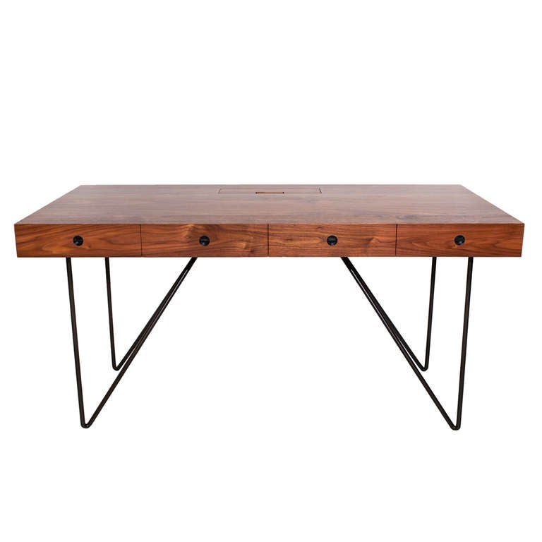 Made of American Black Walnut and wrought steel, the Quilombo desk is a savvy update on colonial utilitarian farm furniture. Their simple and geometric lines, a nod to mid-century modern design, contrast with the reclaimed wood and artisanal