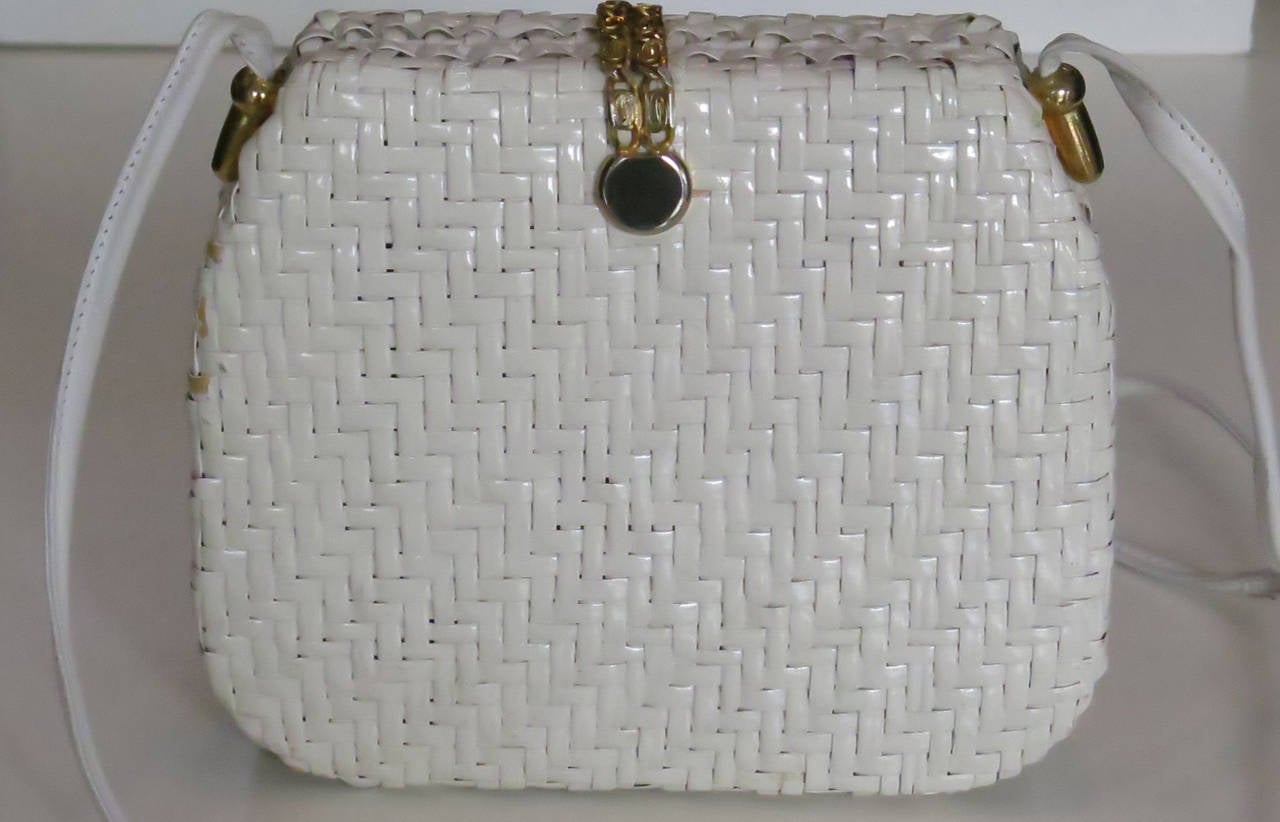 1970s Courreges white raffia purse with gold logo chain magnetic closure. Strap measures approximately 53