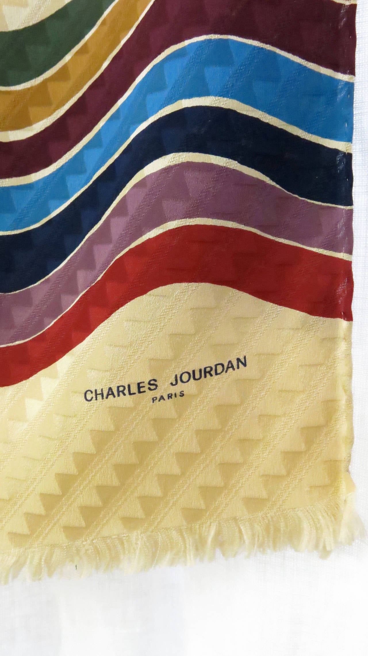 1970s silk scarf by Charles Jourdan, featuring rich hues in a wavy pattern and accented with fringed edges. 

*Please contact dealer prior to purchase for white glove shipping options*