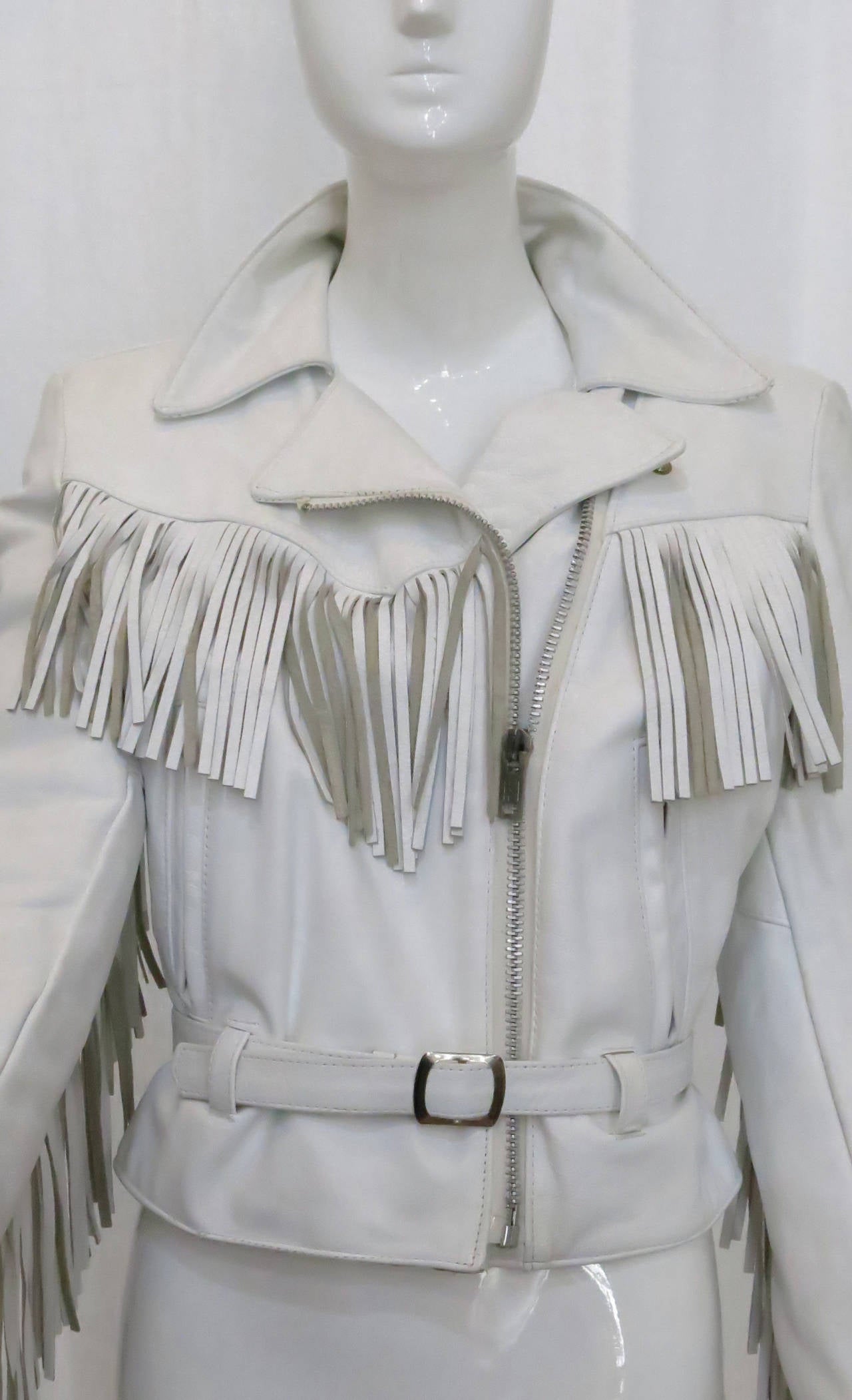 Born to be wild. This white leather fringe motorcycle jacket veers from the pack as a timeless, durable piece for your outerwear wardrobe in eye-catching white. This jacket is heavy duty and cinches at the waist with a belt in the front as well as a