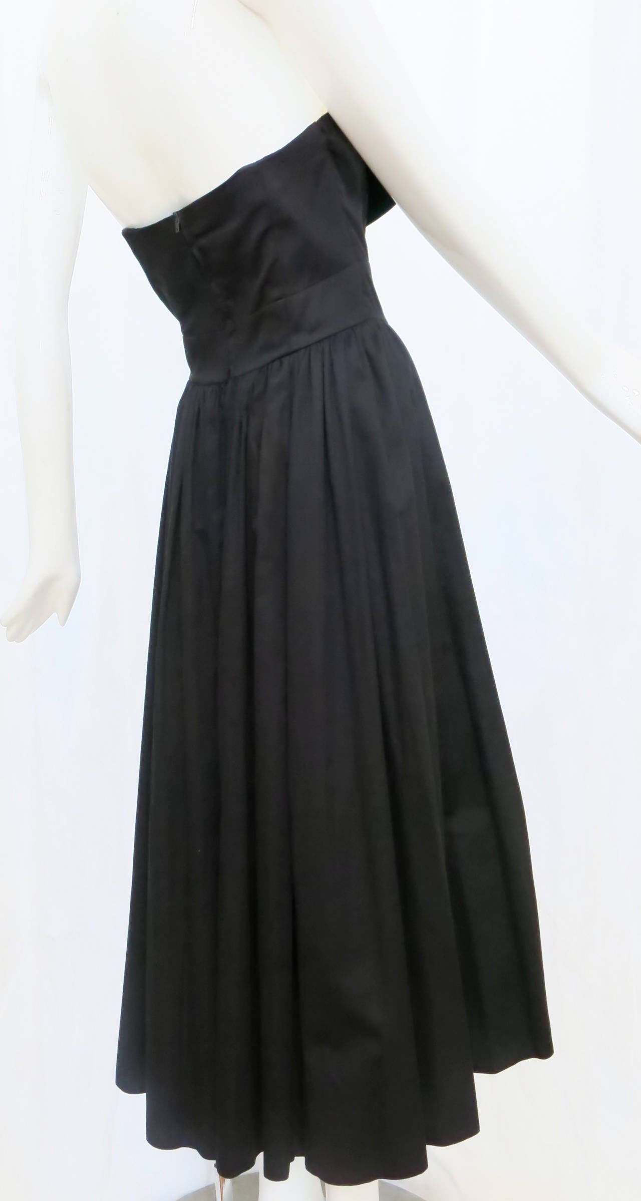 A departure from Laura Ashley's signature pastel palette and floral patterns, this cool cotton strapless black dress unfolds at the bust to reveal a warm marigold panel, making it suitable for day or evening wear. Made in Hungary.

*Please contact