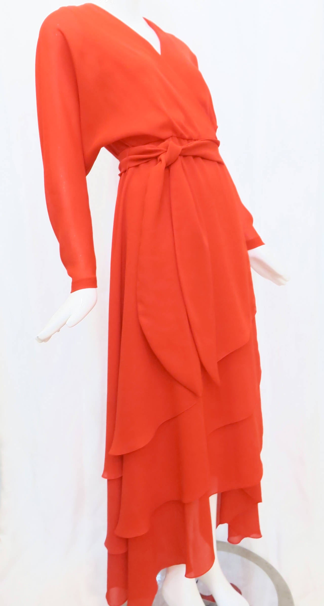 Indicative of the era when fashion reached new levels of expressing and celebrating movement with the body, this 1970s fire red chiffon wrap dress from Robert Courtney fits the bill as a dress that exudes sensuality and elegance. Perhaps what makes