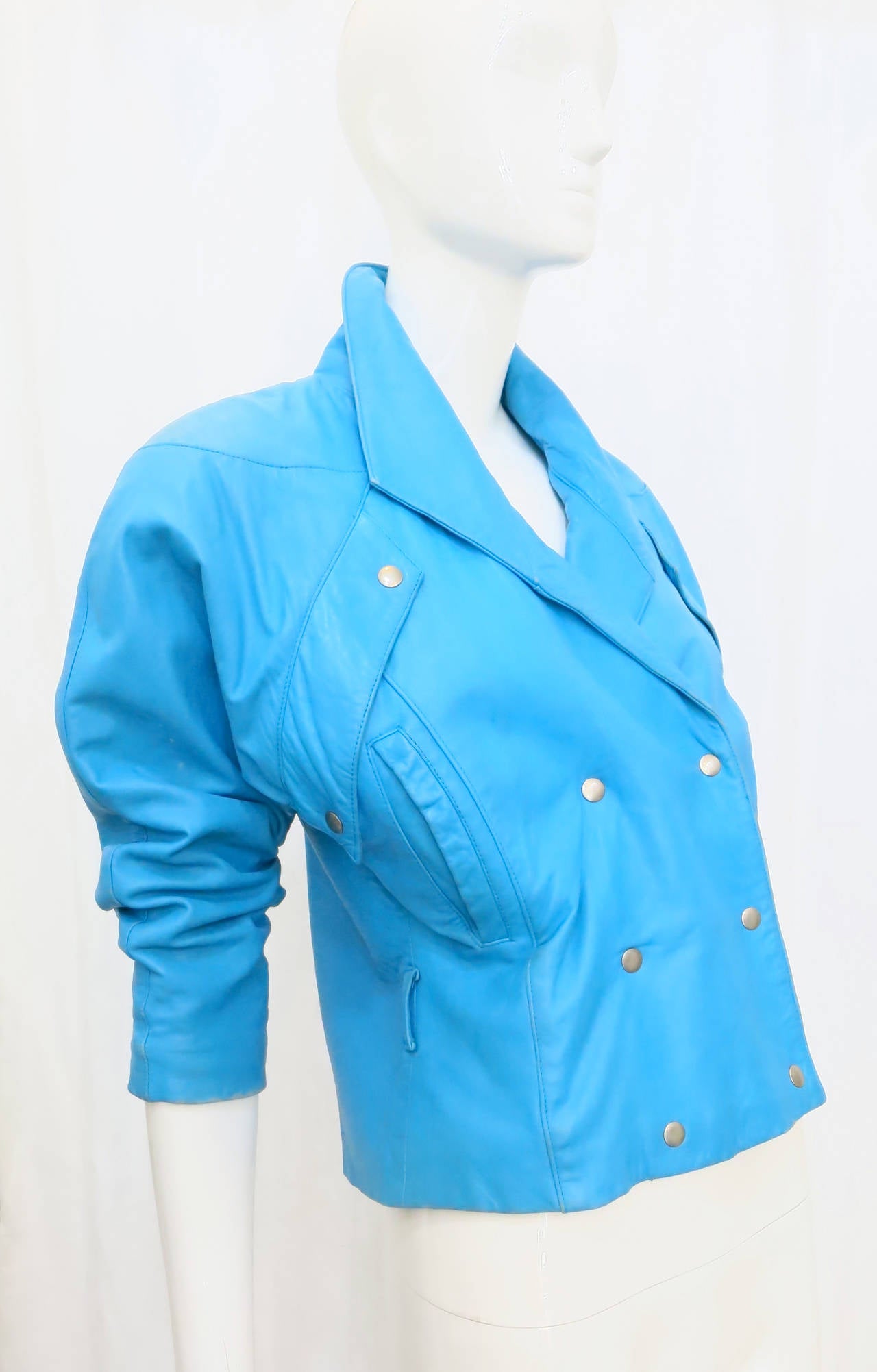 Stand out from the crowd with this vibrant 1980s electric blue motorcycle jacket from Michael Hoban. 

Additional measurements: 16