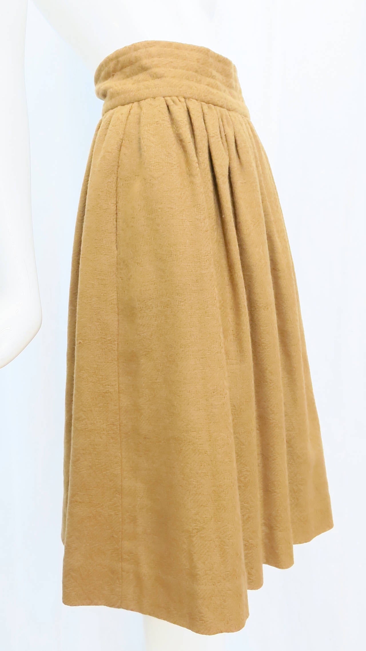 Minimal and versatile, this rustic maxi wool skirt from Valentino is a classic staple for your cool-weather wardrobe. With a nod to tailored style, the band around the waist on this skirt resembles a cummerbund, fastening on the side with three