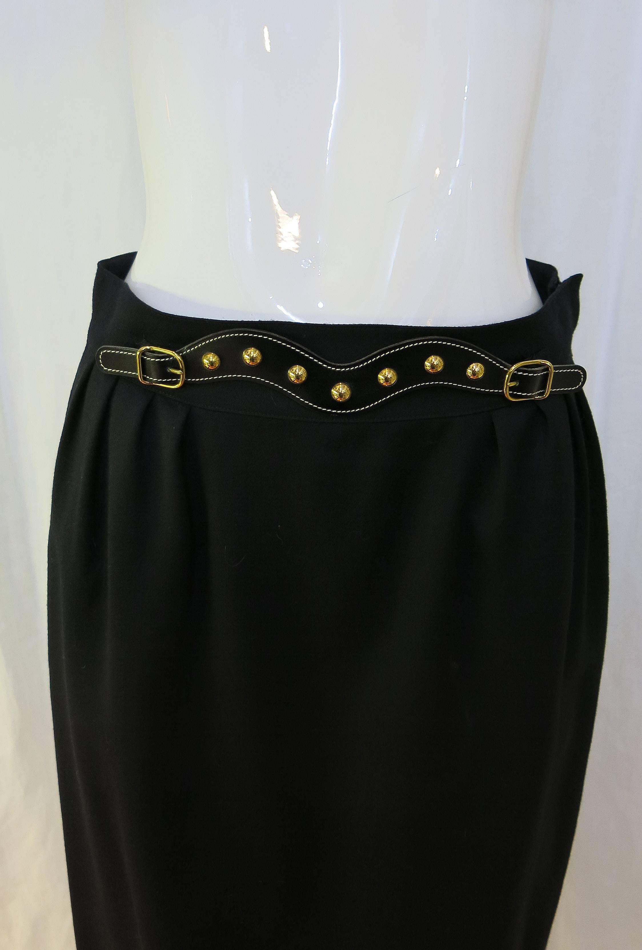 100% wool high waisted, knee length pencil skirt with decorative belt detail on front waist. Skirt has side pockets on either side and also zips on the side.

The skirt is timeless and would make a nice warm addition to any workplace wardrobe.