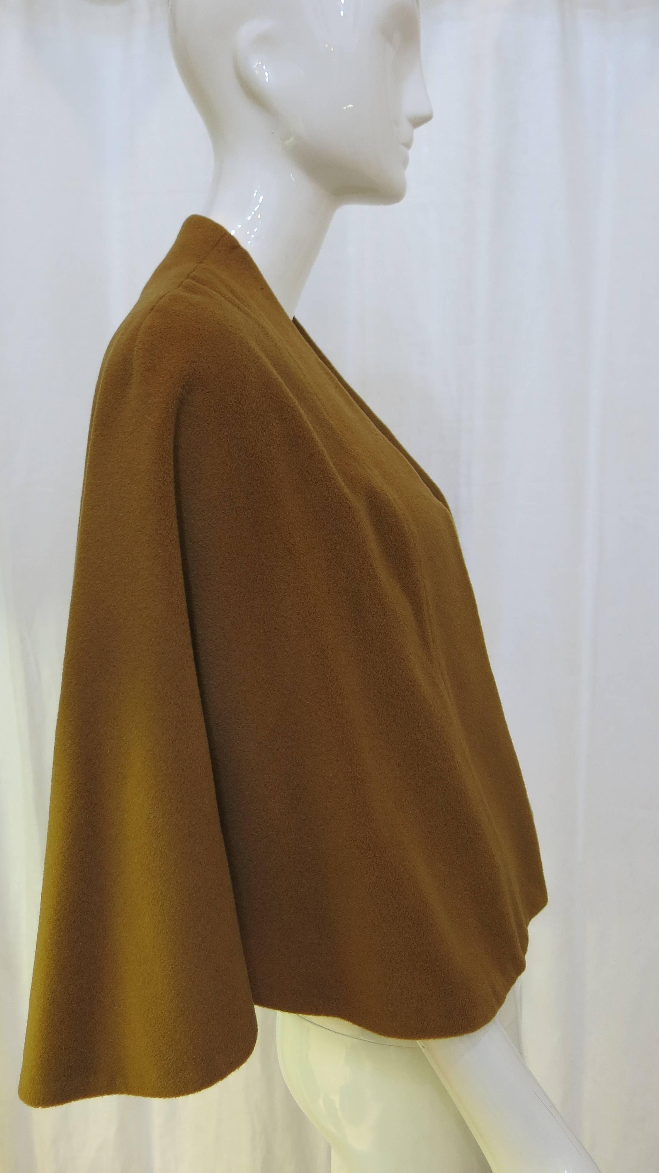 Chestnut brown silk lined open cape made from velvety vicuna wool.

The cape is in great condition with only a few very small marks in the fabric.

Could be paired with a brooch or a clothing pin for closure or simply left to rest on the
