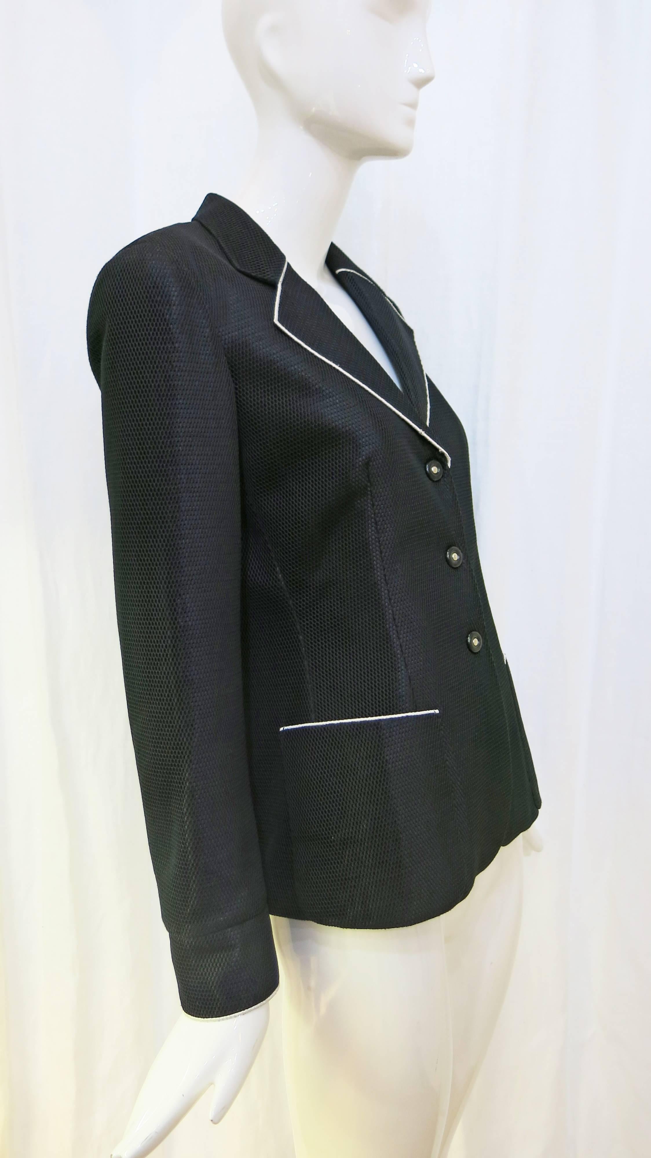 Black blazer with white trim and three snap buttons. Jacket has two front pockets and a mesh overlay on the outer layer. 

Jacket is a size 42 IT which is the equivalent of about a size 6 in US sizing. 

A perfect suiting addition to the