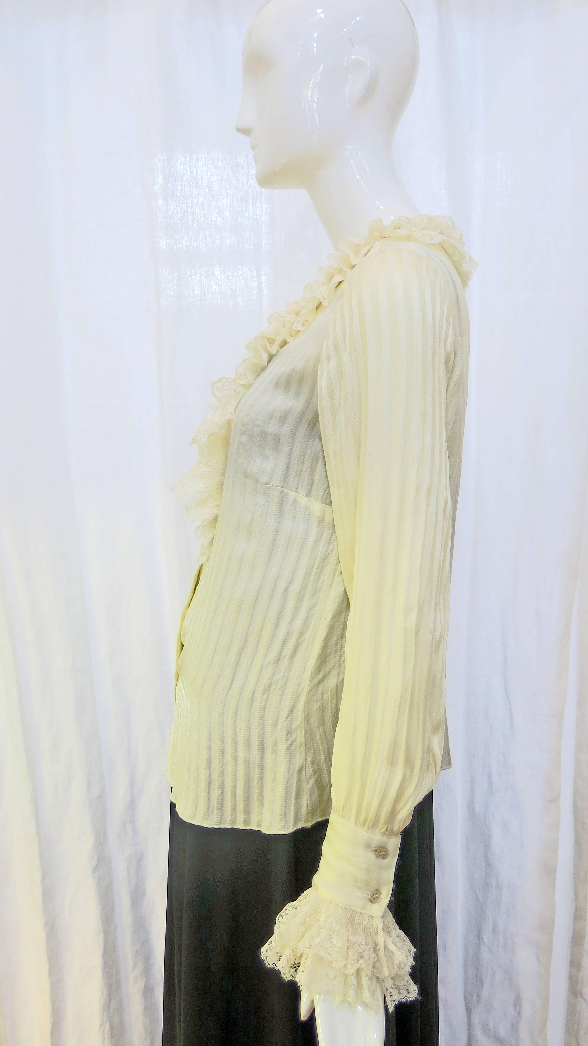 Lightweight cream colored delicately adorned silk button down blouse with lace detailing and subtle striping. Buttons at the sleeves and is collarless. 

Edwardian influenced and a bit dramatic, this piece is a staple which could be paired with an