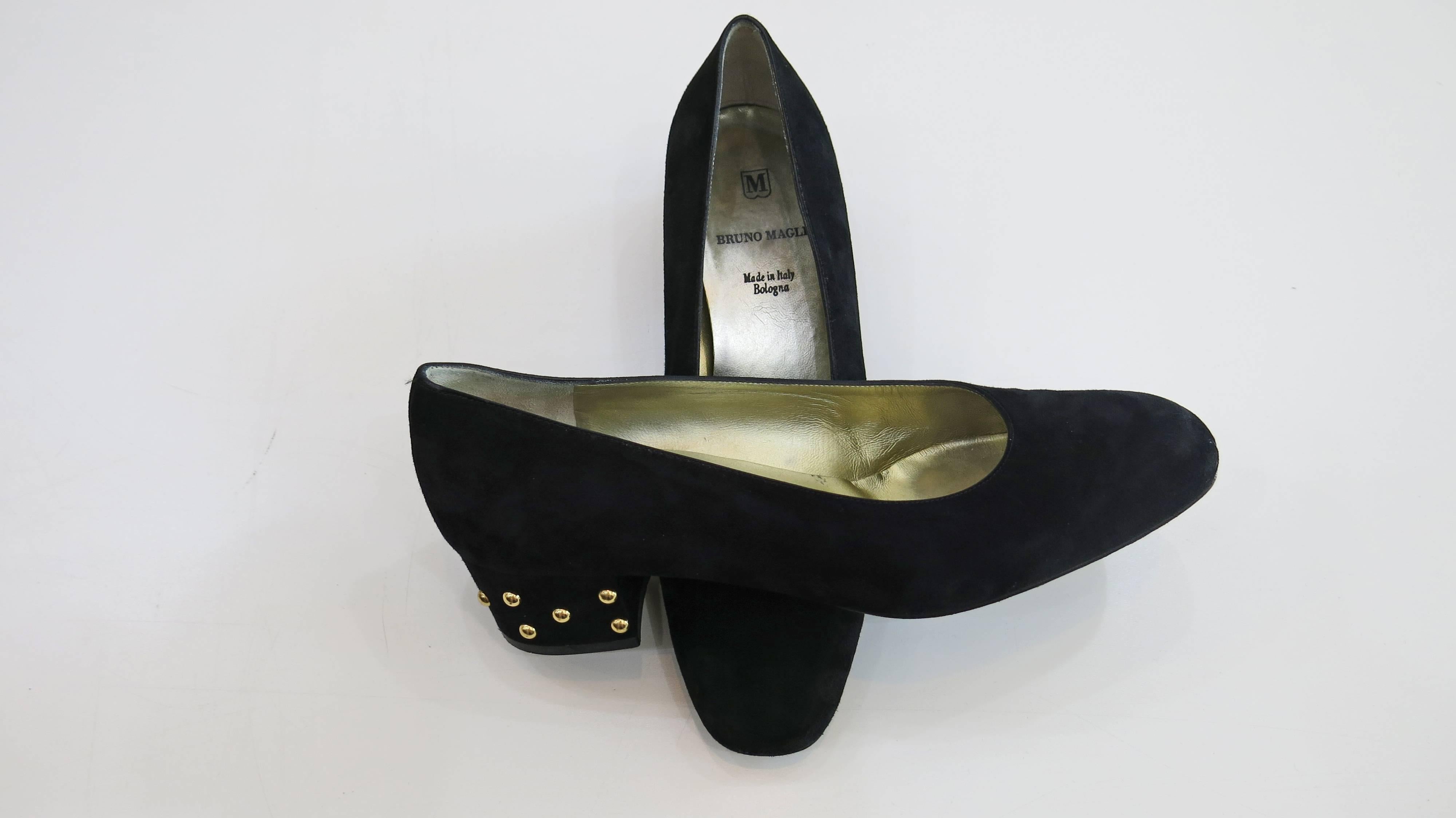 Black suede upper 2 inch heels with gold tone studs. Gold leather lining with brand stamp and black leather sole. Made in Italy. Some wear and discoloration on inside of the shoe. Some wear to the suede as well as minor loss of color on the outside