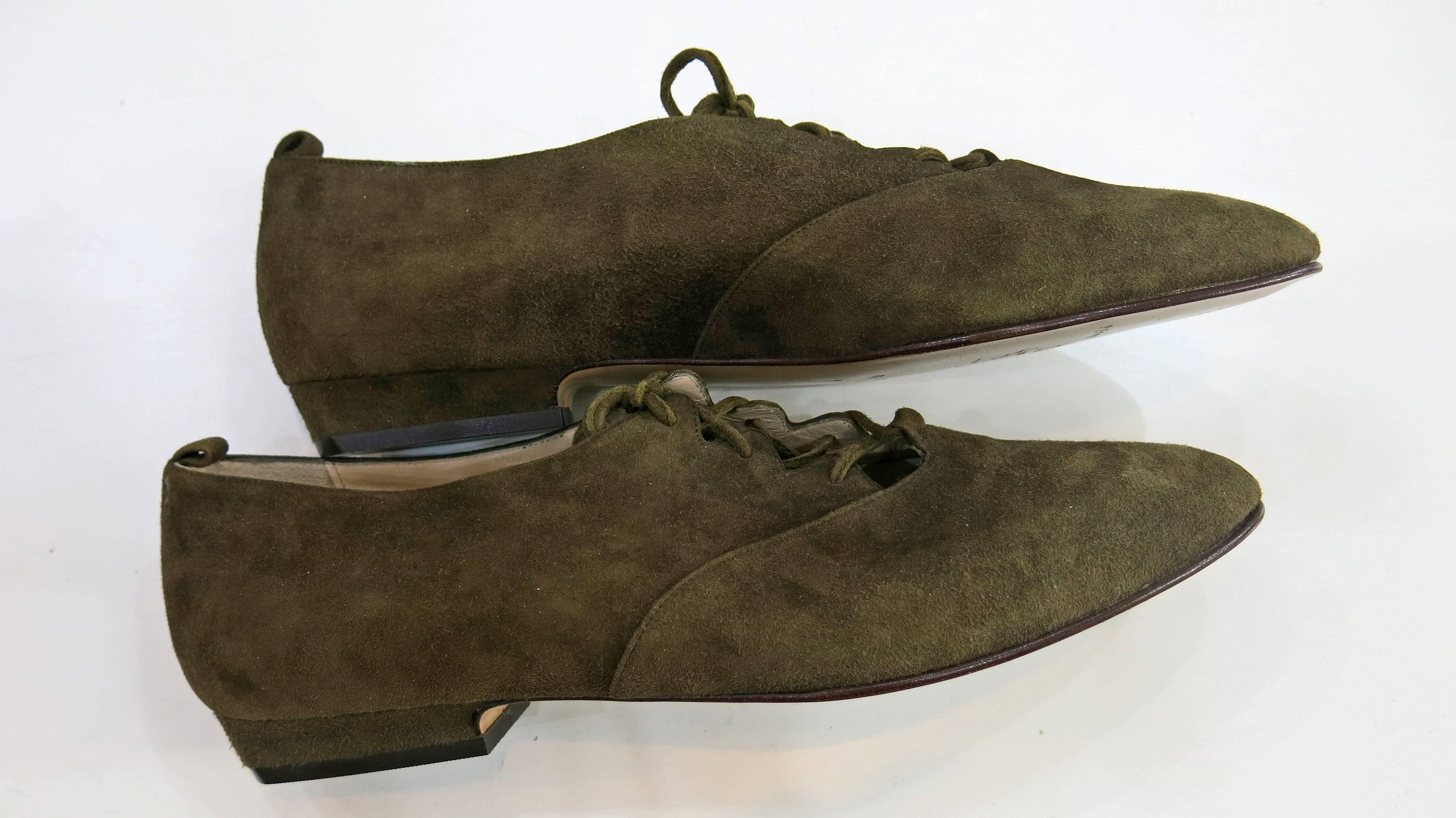 Dark green suede lace up flats with a slightly rounded pointed toe. Leather lining and sole. Made in Italy. Some slight wear on the outer shoe but the soles are in perfect condition and the shoes look unworn. With original box. Please see