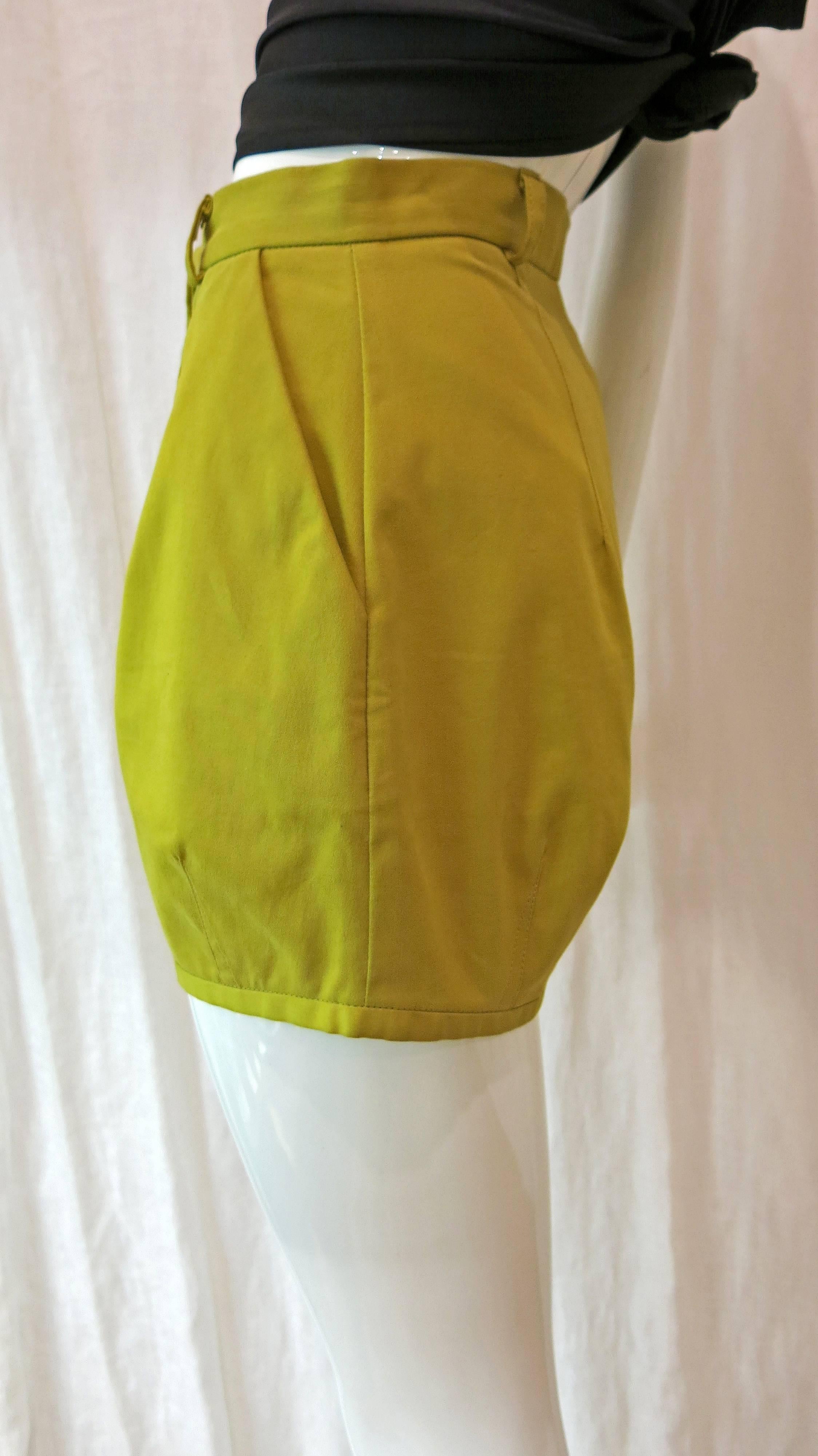 Chartreuse tiny, well-crafted shorts. Could be worn alone or with tights and a cropped sweater for a fun fall look. Single button and zip closure at front. Two front pockets, no back pockets. Unworn- still have original Vivienne Westwood Anglomania
