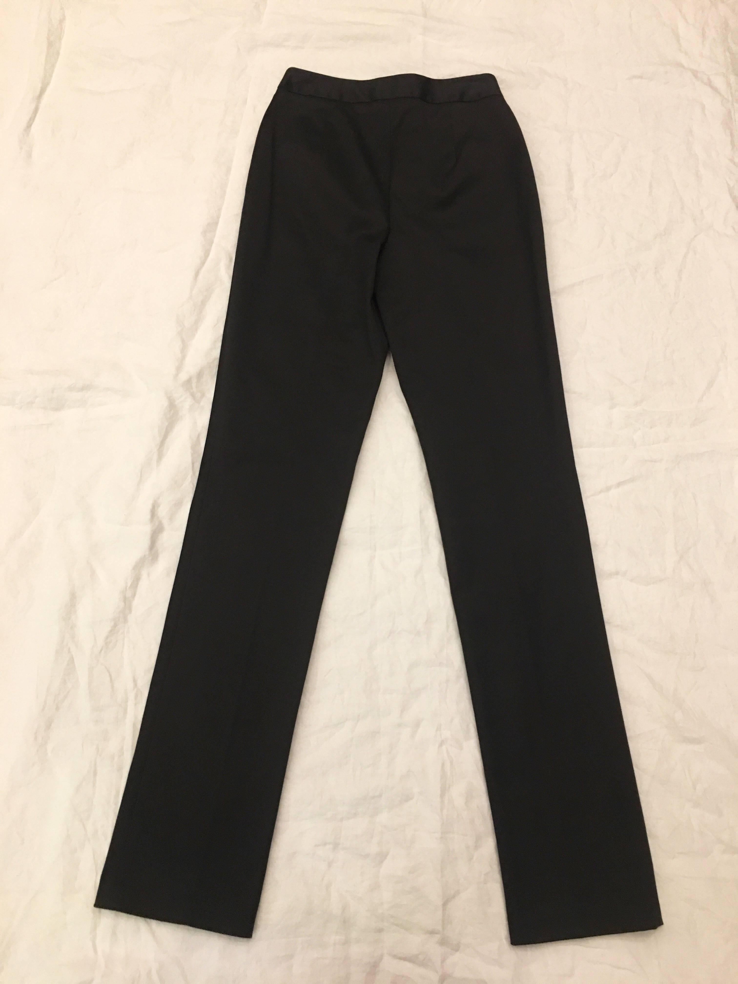 Black straight leg pants by Dolce and Gabbana. Two front pockets at waist. Dress them up or down. A versatile every day pant for office wear or casual day off errands. 