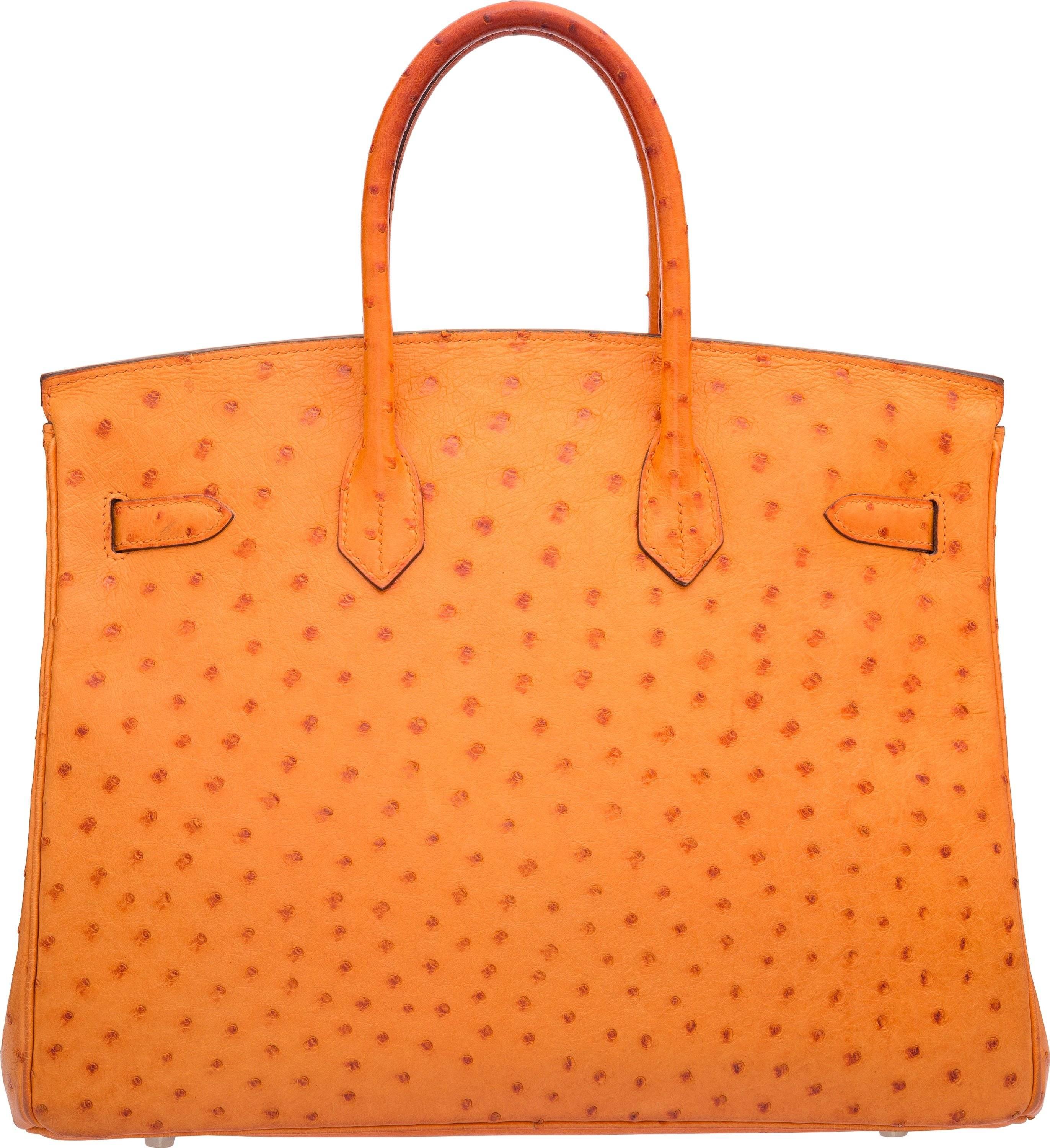 This Birkin bag is done in Tangerine Ostrich, featuring two rolled handles, Palladium Hardware, and a flap top with a turnlock closure. The interior is done in matching Tangerine Chevre Leather, featuring one zip pocket and one slip pocket. This bag