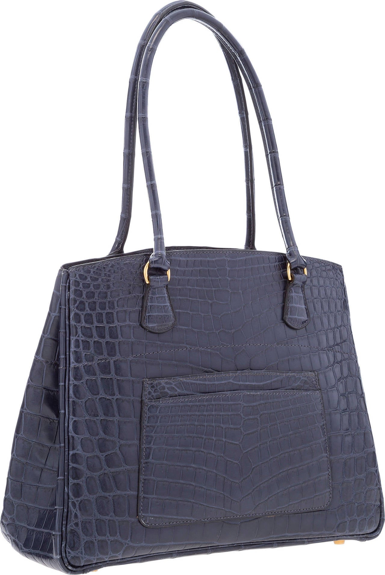 This Hermes bag is a chic and simplistic shoulder bag.  Done in Matte Indigo Nilo Crocodile, this bag's deep color make it a great option for day or night. This bag features two shoulder straps, two front exterior slip pockets, snaps on both sides