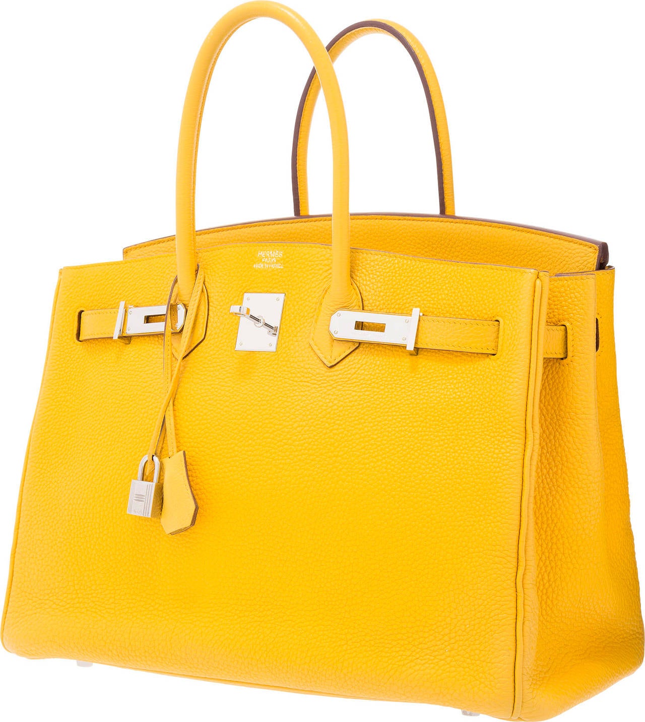 This Birkin is quite the standout. The Hermes Birkin bag has become one of the most desired luxury status symbols. The Birkin is cherished for its functional design and lasting value. This particular Birkin is done in a bright Soleil and accented