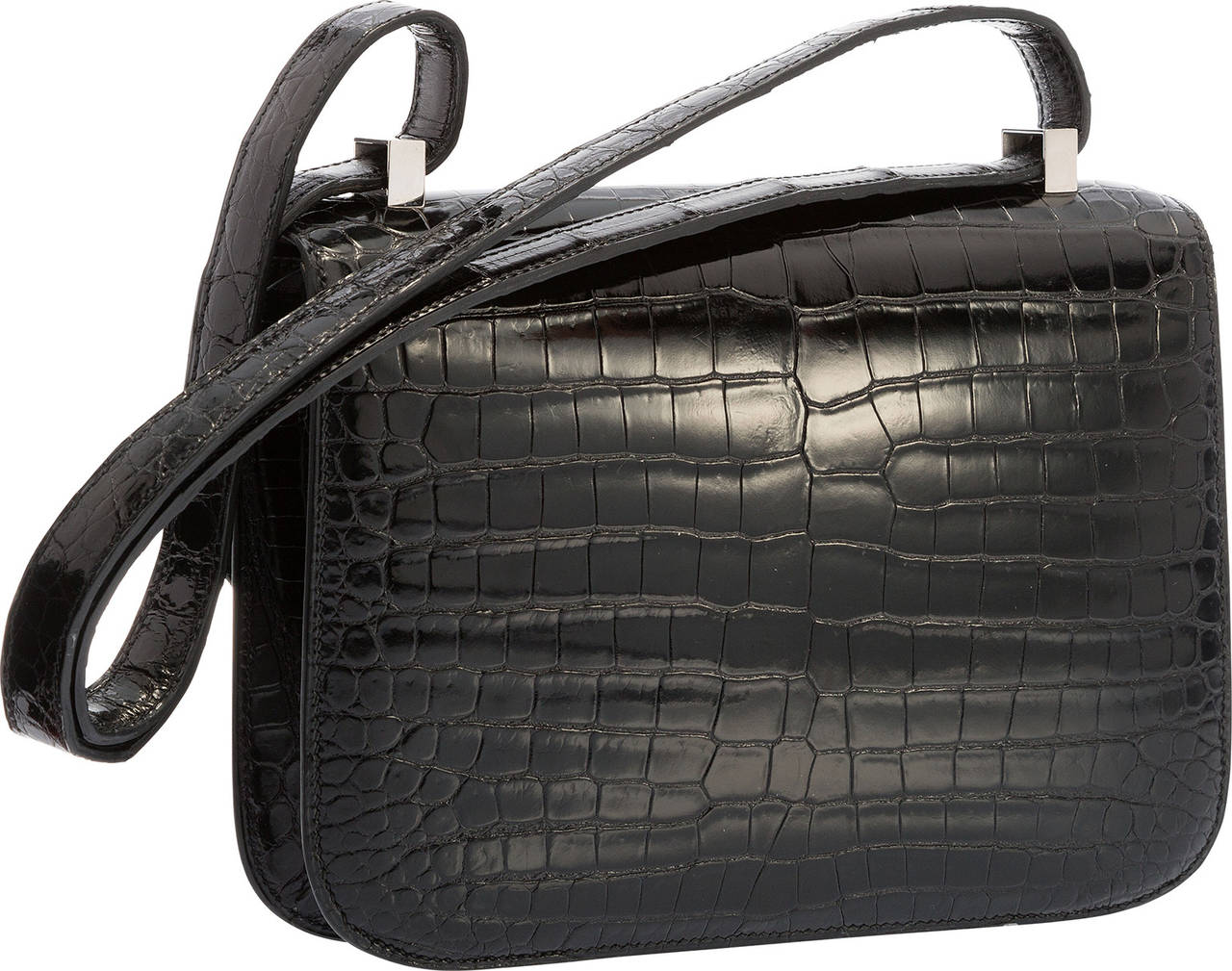 The Hermes Constance is quickly gaining popularity amongst savvy collectors. The Constance was designed in the 1960s and it has stood the test of time. This particular Constance is done in Shiny Black Porosus Crocodile, and accented with Palladium