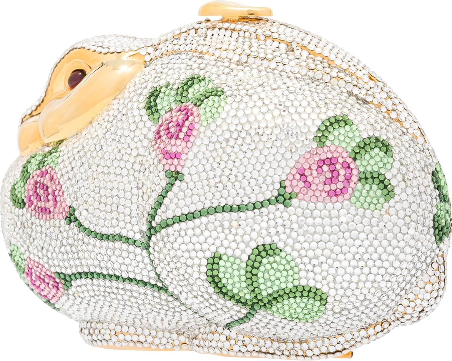 HOP into spring with this adorable rabbit inspired Judith Leiber minaudiere! As with many of her figural pieces, this rabbit has a sweet, whimsical nature. Done in an array of sparkling silver crystals, the rabbit is accented with a pink and green
