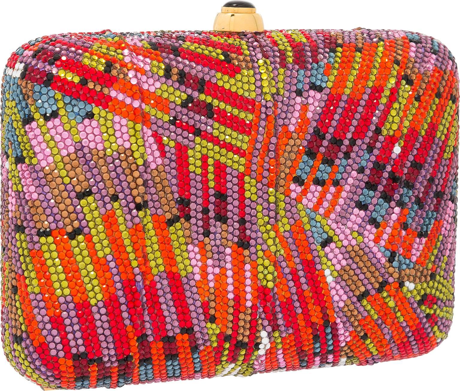 Add a flare of color to an evening ensemble with this simply mesmerizing evening bag. With a fauvist display of red, silver, purple, blue, green and orange Austrian crystals, this clutch is sure to turn heads and get double-takes. Finished with a