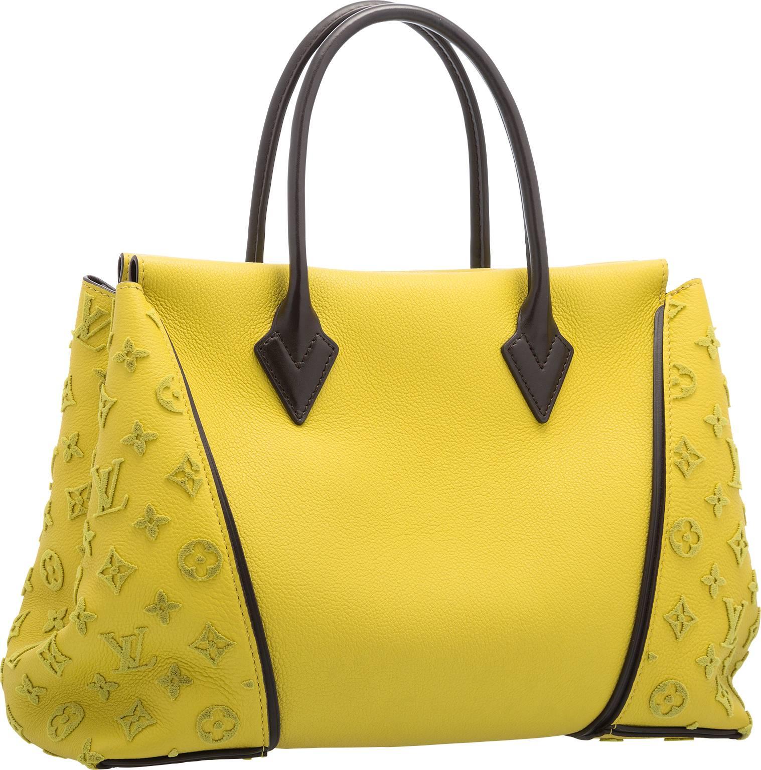 Chic, on trend, and fabulous, the W Bag from Louis Vuitton is an impressive combination of their most luxurious leathers available. This bag is done in supple yellow and brown leather, featuring matching yellow monogram tuffetage side detail. This